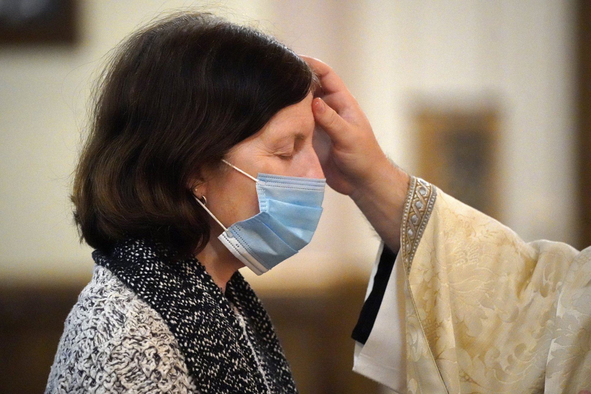 A priest anoints a woman’s forehead with the oil of the sick during a healing Mass at his parish in this 2022 file photo. (CNS/Gregory A. Shemitz)