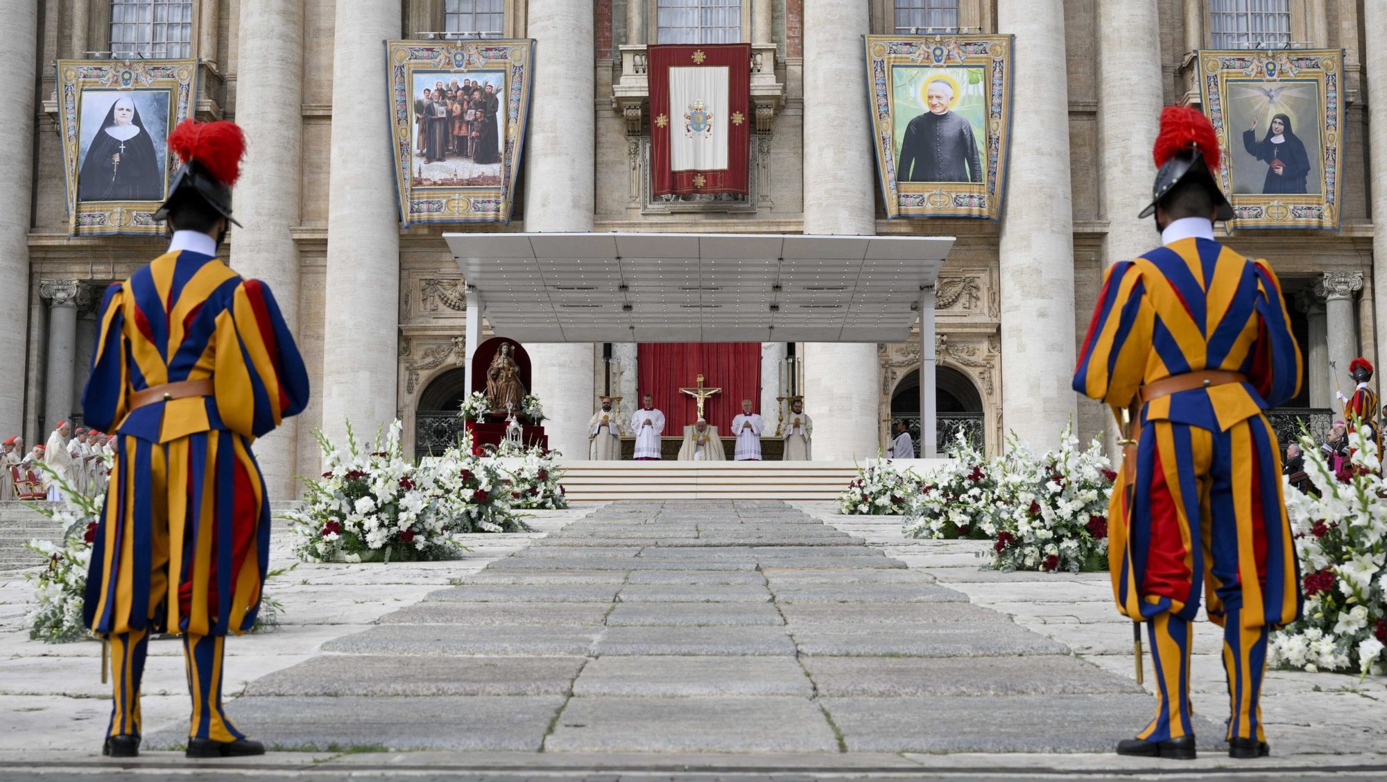 Banners of new saints hang from the facade of St. Peter's Basilica during Mass for the canonization of 14 new saints on World Mission Sunday in St. Peter's Square with Pope Francis at the Vatican Oct. 20, 2024. (CNS photo/Vatican Media)