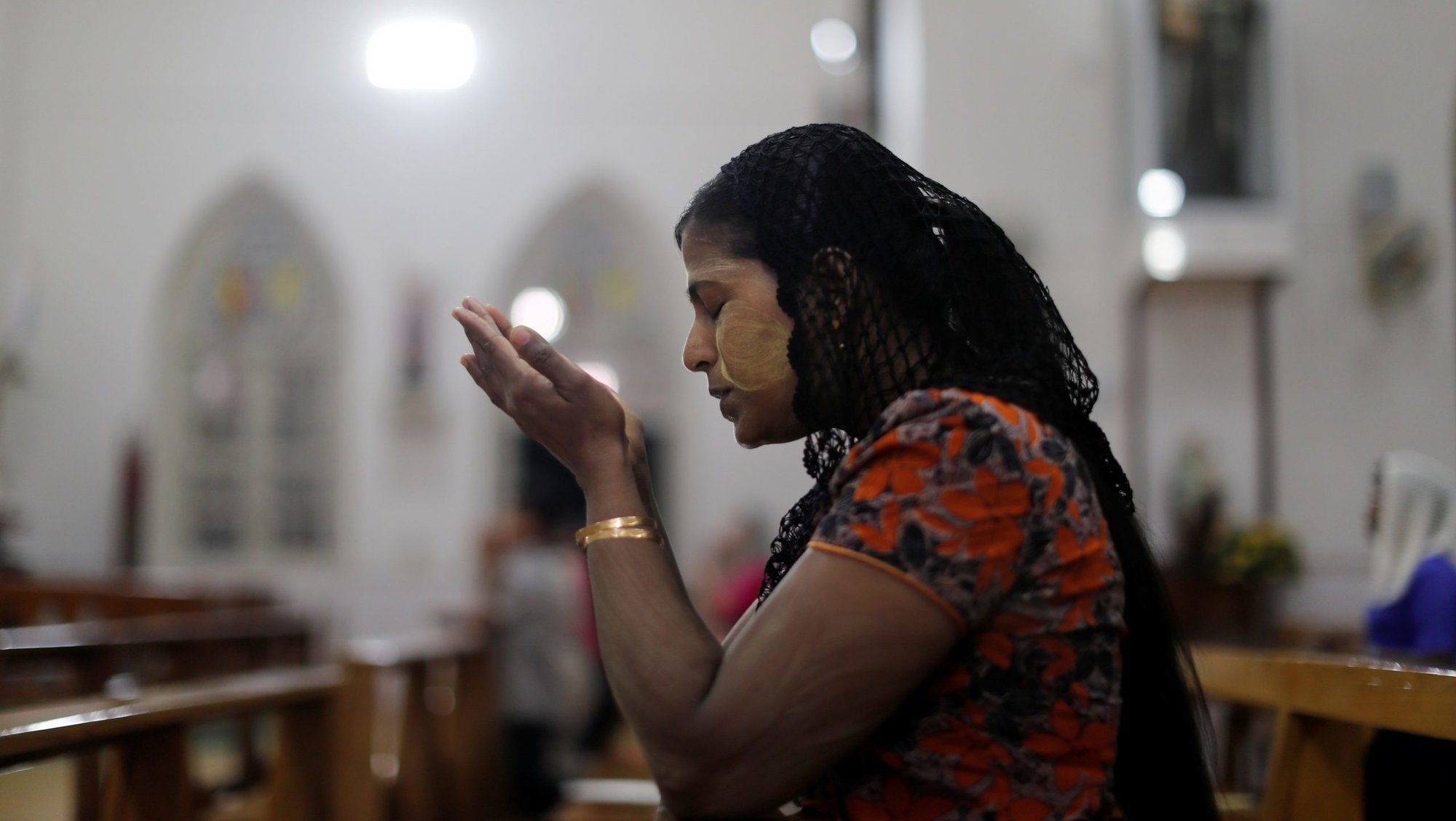 A woman is pictured in a file photo praying at a church in Yangon, Myanmar, Nov. 28, 2017. Fides, the news agency of the Dicastery for Evangelization, reported March 5, 2025, that a pastoral center on the grounds of St. Michael's Catholic Church in Nan Hlaing, located in the northern Diocese of Banmaw was targeted and destroyed by two aerial bombs. (OSV News photo/Jorge Silva, Reuters)