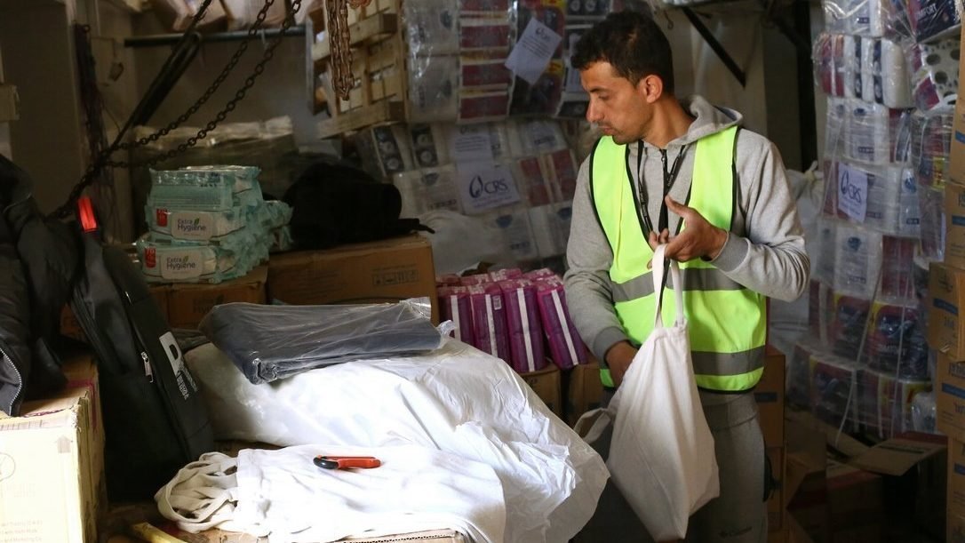 A humanitarian aid worker is pictured in a file photo packing Catholic Relief Services relief supplies in Rafah, in the southern Gaza Strip, for distribution to people displaced in war-torn Gaza. (OSV News photo/Mohammad Al Hout for CRS)