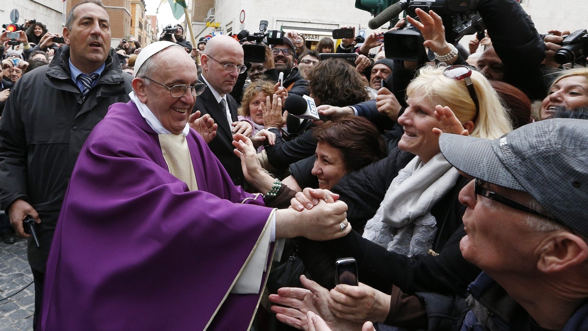 Pope Francis smiles as he greets people after celebrating Mass at the Church of St. Anne within the Vatican March 17, 2013. The pope wants the church to be holy and joyful. (CNS photo/Paul Haring)