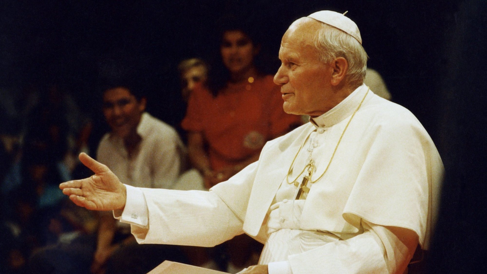 A young and relaxed Pope John Paul II answers questions from young people during a 1987 teleconference in Los Angeles. He was canonized on April 27, 2014. (OSV News photo/Joe Rimkus Jr.)