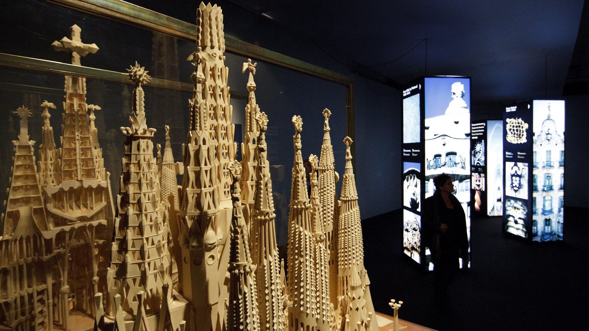 A model of Spanish architect Antoni Gaudi's Basilica of the Sagrada Familia in Barcelona is seen next to images of his other work in a Vatican exhibit Dec. 1, 2011. (CNS photo/Paul Haring)