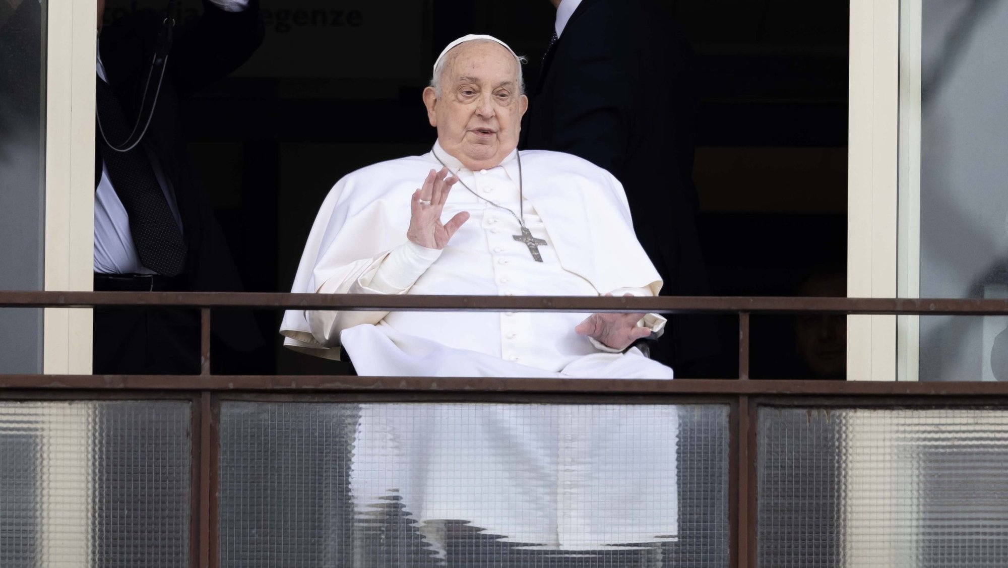 Pope Francis, whose arms are bandaged, waves to a crowd of well-wishers at Rome's Gemelli hospital before returning to the Vatican March 23, 2025, after 38 days of treatment at the hospital. (CNS photo/Pablo Esparza)