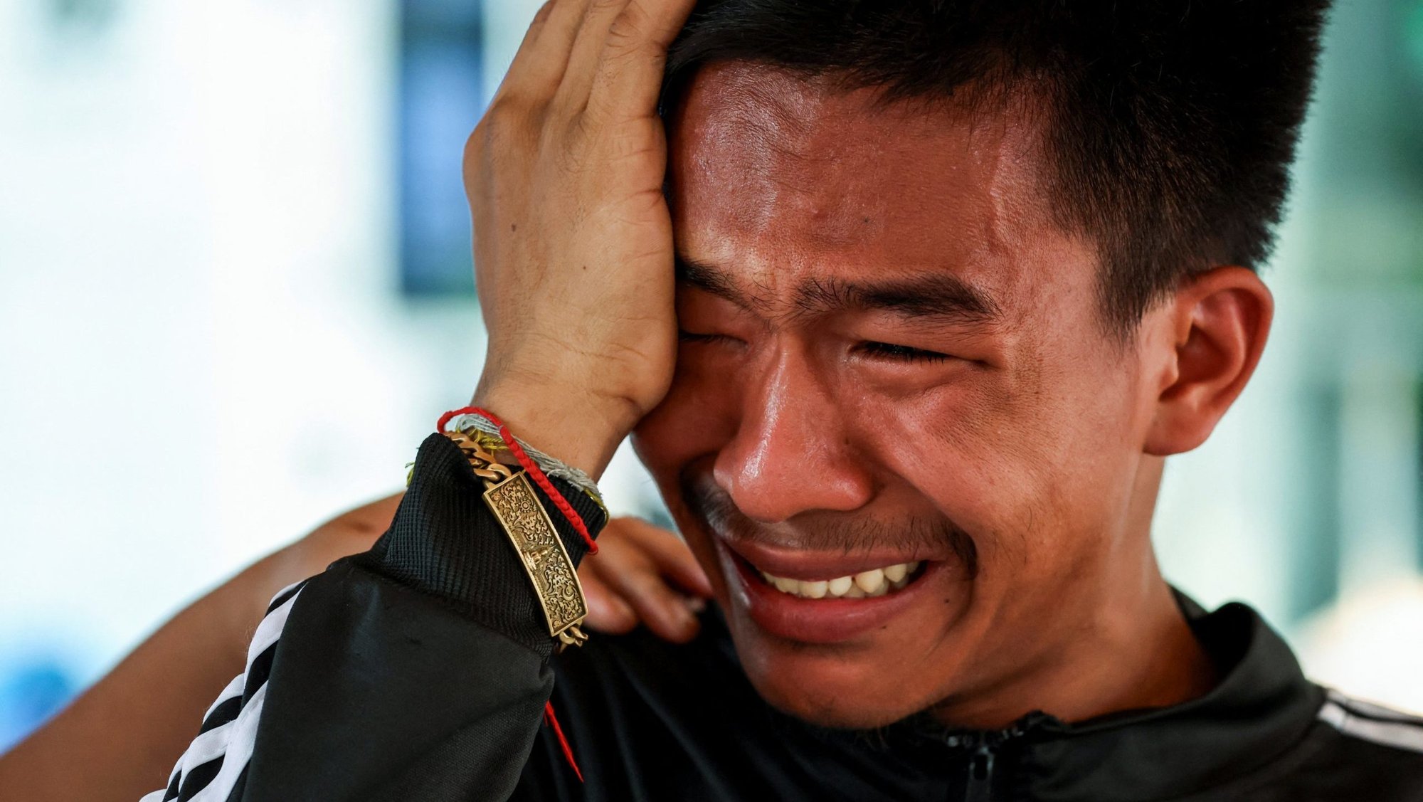A migrant worker from Myanmar reacts while he waits for news about his brother, as search and rescue operations continue in Bangkok, Thailand, April 1, 2025, following a 7.7 magnitude earthquake that hit midday March 28. Rescue workers saved a 63-year-old woman from the rubble of a building in Myanmar’s capital Naypyitaw April 1, but hope was fading of finding many more survivors of the violent earthquake that killed thousands, compounding a humanitarian crisis caused by a civil war. (OSV News photo/Chalinee Thirasupa, Reuters)