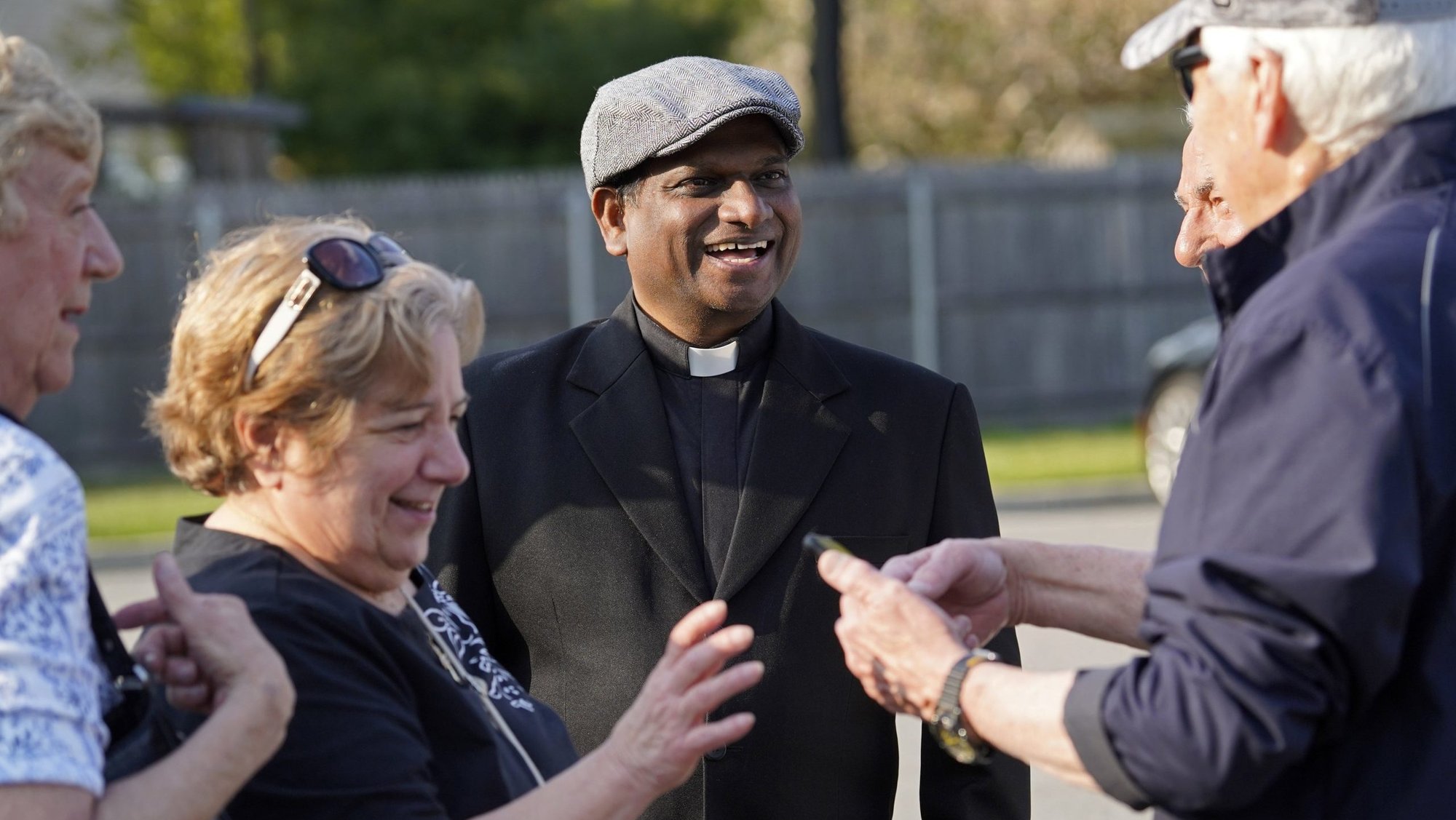 Father Charles Gnanapragasam, a priest from India, chats with well-wishers following a "Keep Our Priests" rosary rally at St. Mary Church in East Islip, N.Y., April 29, 2024. (OSV News/Gregory A. Shemitz)