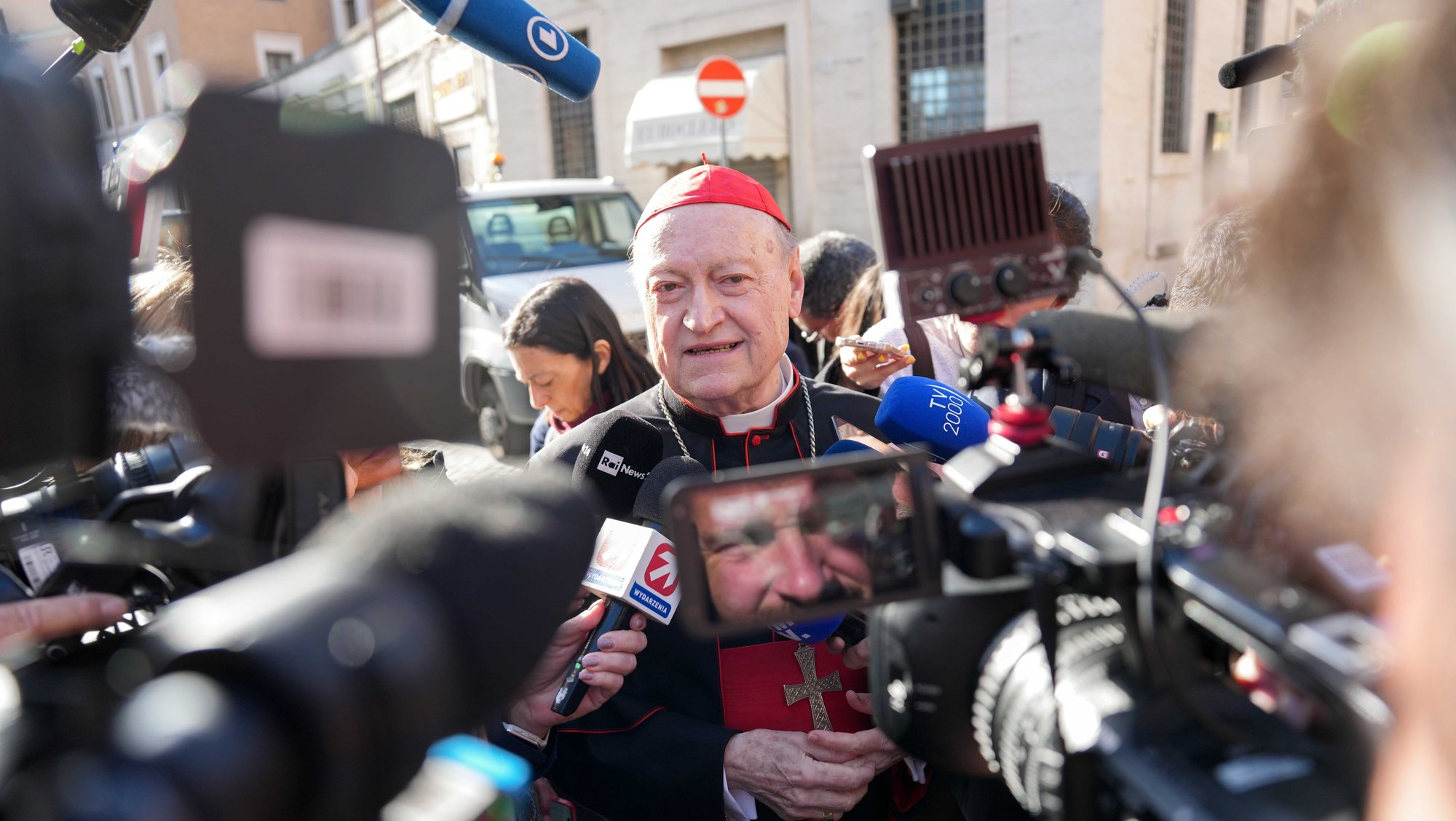 Retired Italian Cardinal Gianfranco Ravasi, speaks with the press as he approaches the Petriano entrance next to St. Peter's Square to attend the first meeting of cardinals in the Synod Hall at the Vatican April 22, 2025. (CNS photo/Lola Gomez)