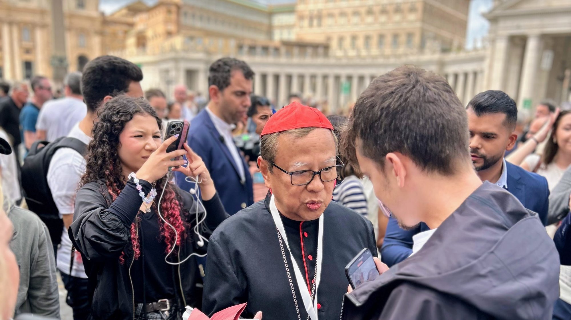Cardinal Ignatius Suharyo Hardjoatmodjo of Indonesia blesses a pilgrim’s religious articles while taking questions from the media in St. Peter’s Square May 5, 2025. (Pablo Kay)