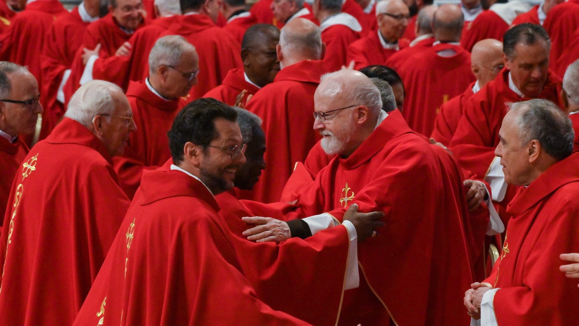 Cardinals exchange a sign of peace while concelebrating Mass in St. Peter's Basilica at the Vatican April 29, 2025, on the fourth day of the "novendiali" -- nine days of mourning for Pope Francis marked by Masses. (CNS photo/Chris Warde-Jones)