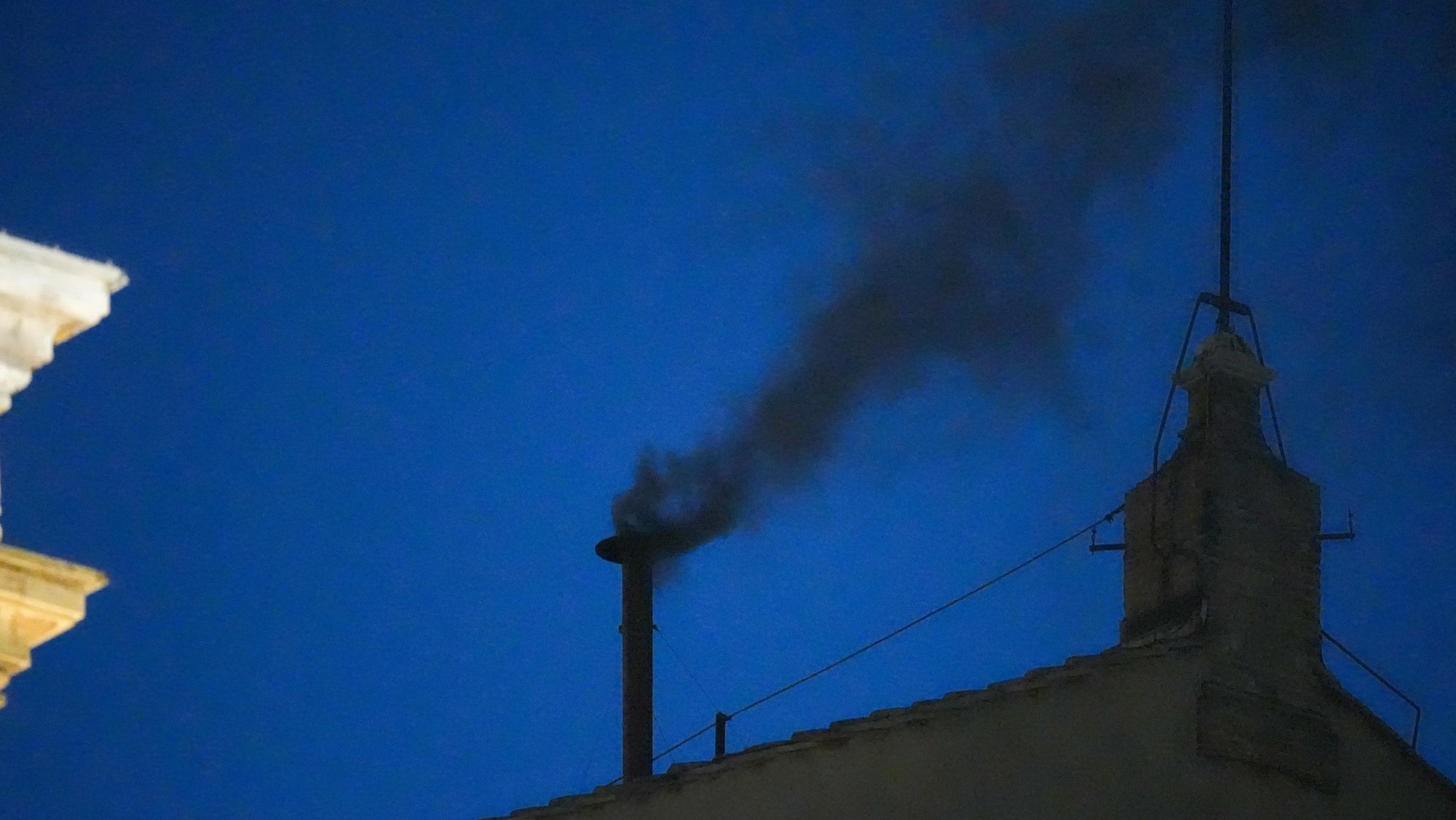 Black smoke billows from the chimney atop the Sistine Chapel May 7, 2025, on the first day of the conclave at the Vatican. (CNS/Lola Gomez)