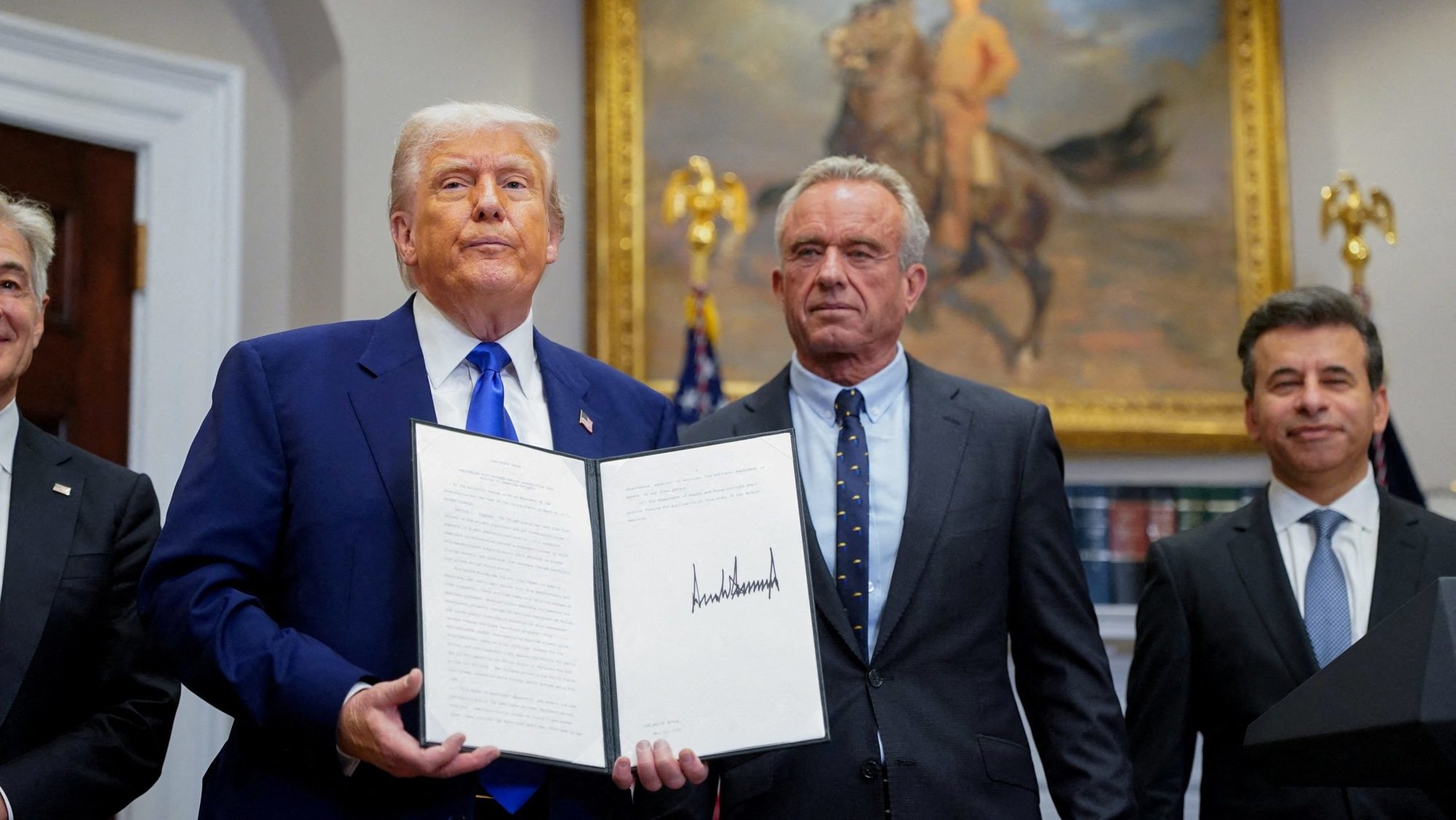 U.S. President Donald Trump holds an executive order on prescription drug pricing next to U.S. Health and Human Services Secretary Robert F. Kennedy, Jr., during a news conference in the Roosevelt Room at the White House in Washington May 12, 2025. (OSV News photo/Nathan Howard, Reuters)