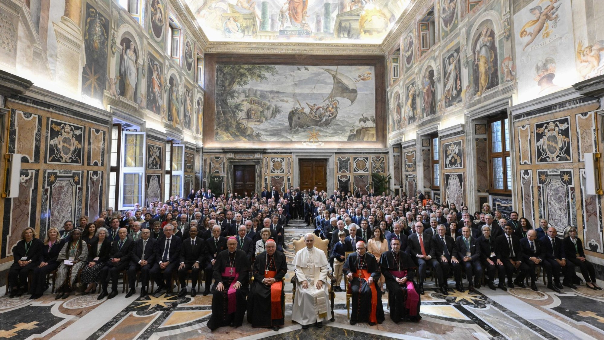 Pope Leo XIV poses for a photo with members of the Centesimus Annus Foundation in the Clementine Hall of the Apostolic Palace at the Vatican May 17, 2025. The pope is seated between French Cardinal Jean-Marc Aveline of Marseille, left, and Cardinal Silvano Tomasi, a retired Vatican diplomat. (CNS photo/Vatican Media)