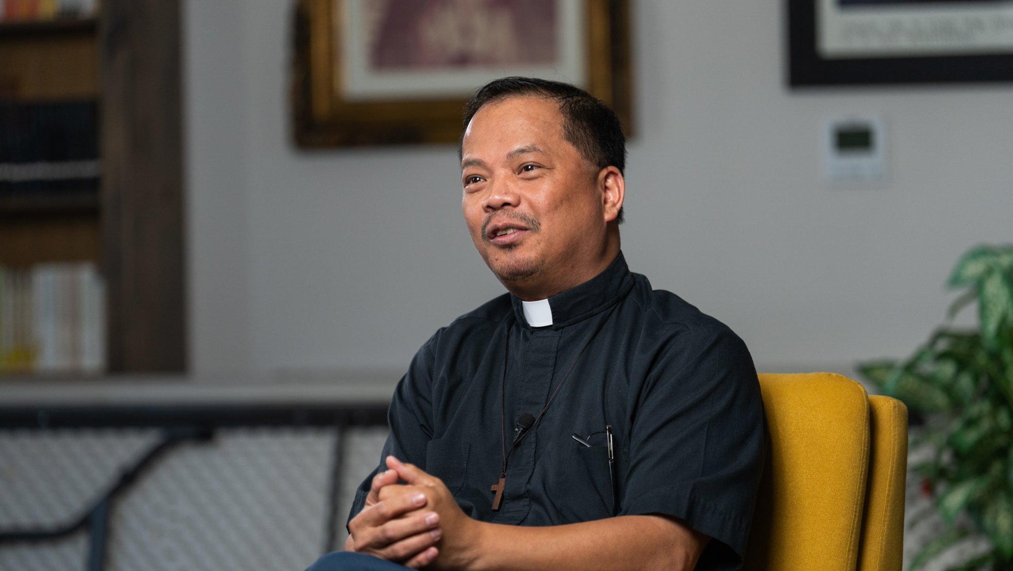 Allan Carodan, a new priest ordained on May 31, sits during a video interview on April 9. (Isabel Cacho)