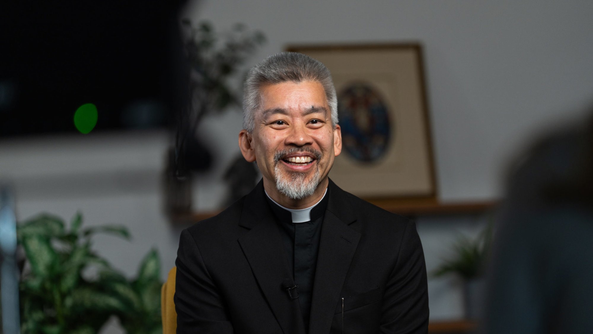 Joseph Cruz, a new priest ordained on May 31, sits during a video interview on April 9. (Isabel Cacho)