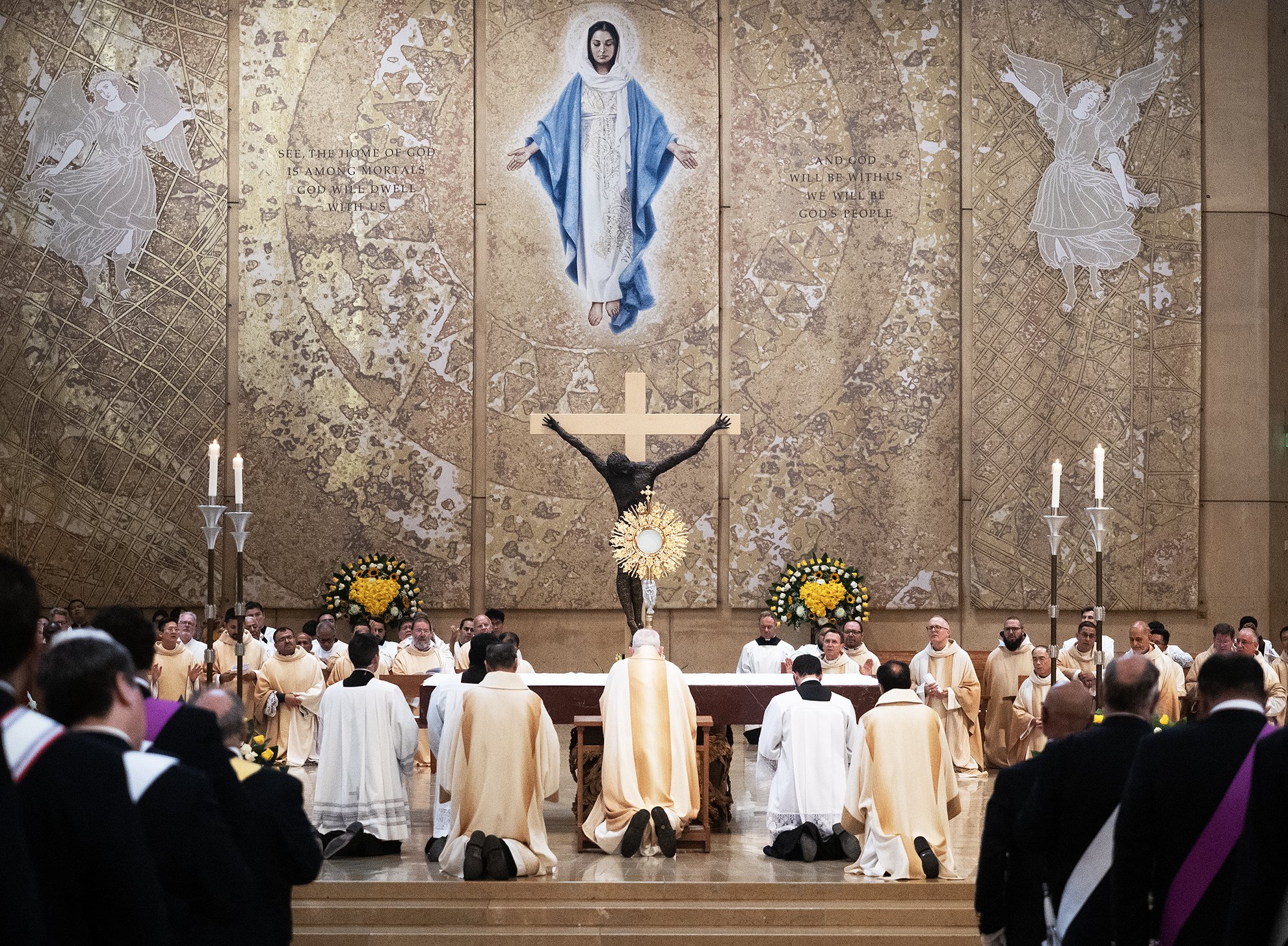 Archbishop José H. Gomez and other priests and bishops venerate the Eucharist during the closing Mass of the National Eucharistic Revival June 22. (Victor Alemán)