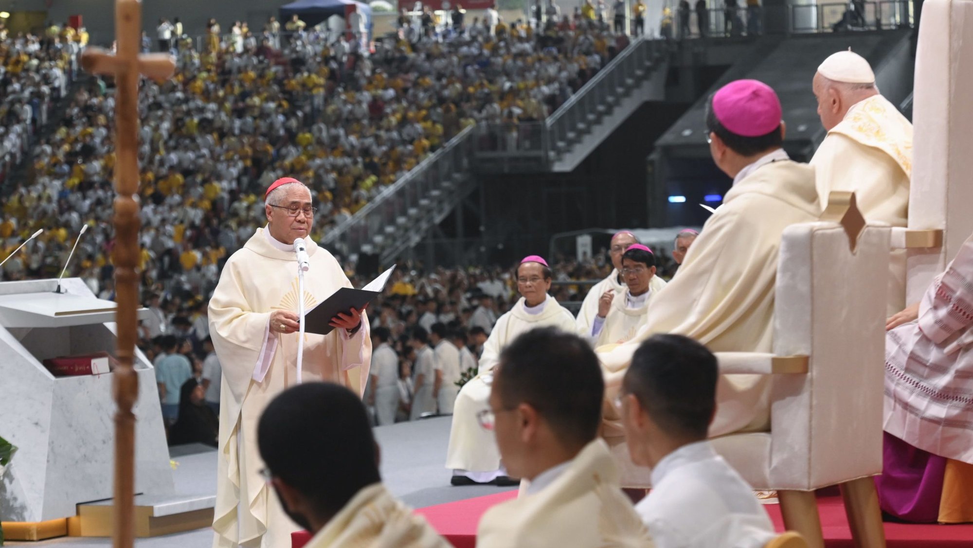 Cardinal William Goh Seng Chye of Singapore speaks to Pope Francis after Mass at Singapore’s National Stadium Sept. 12, 2024. (CNS/Vatican Media)