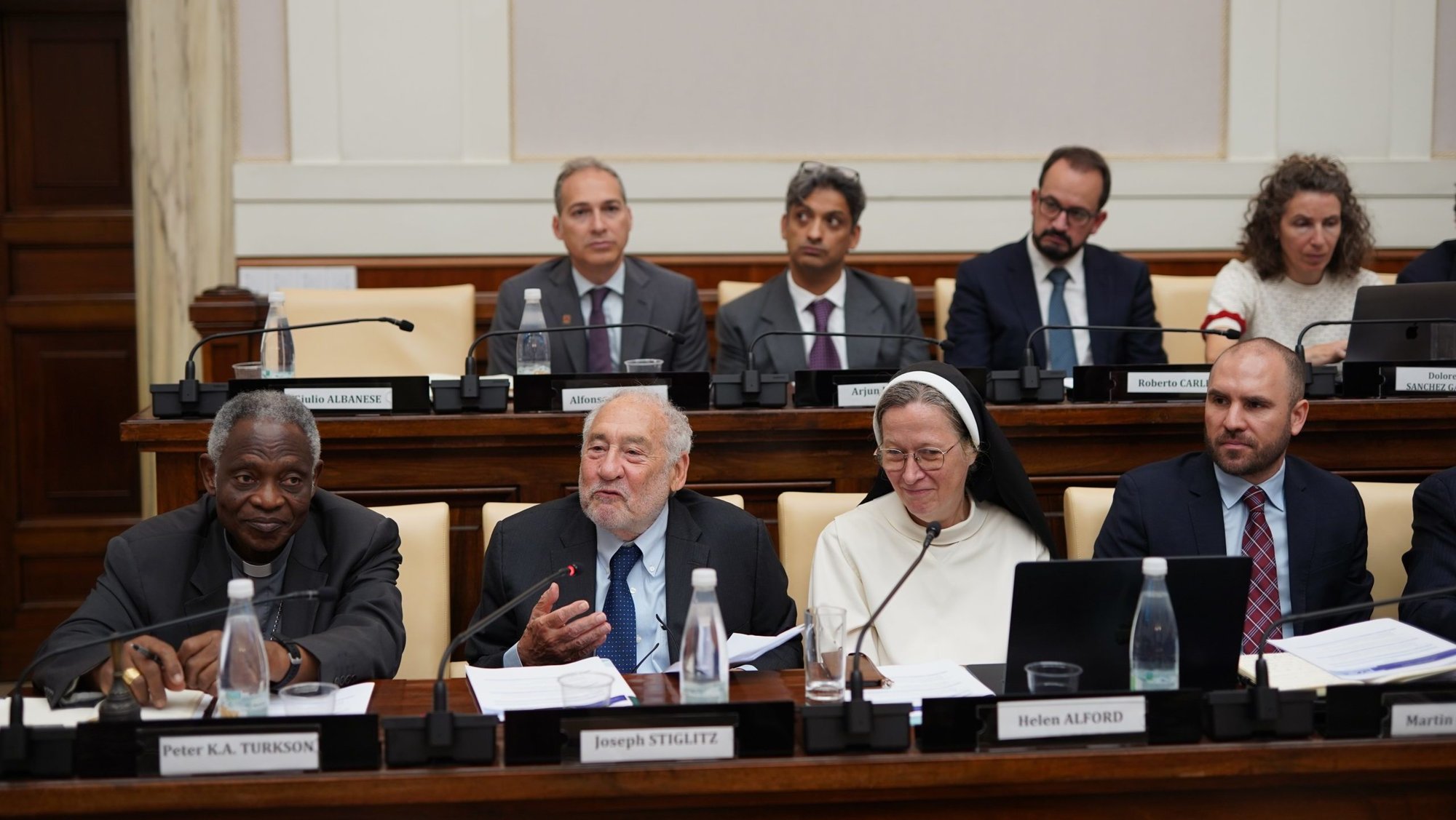 Joseph E. Stiglitz, center, co-chair of the Jubilee Commission, speaks at the presentation of the commission's report June 20, 2025, in the Casina Pio IV in the Vatican Gardens. He is seated between Cardinal Peter Turkson, chancellor of the pontifical academies of Sciences and of Social Sciences, and Dominican Sister Helen Alford, president of the Pontifical Academy of Social Sciences. (CNS photo/Gabriella C. Marino, PASS)