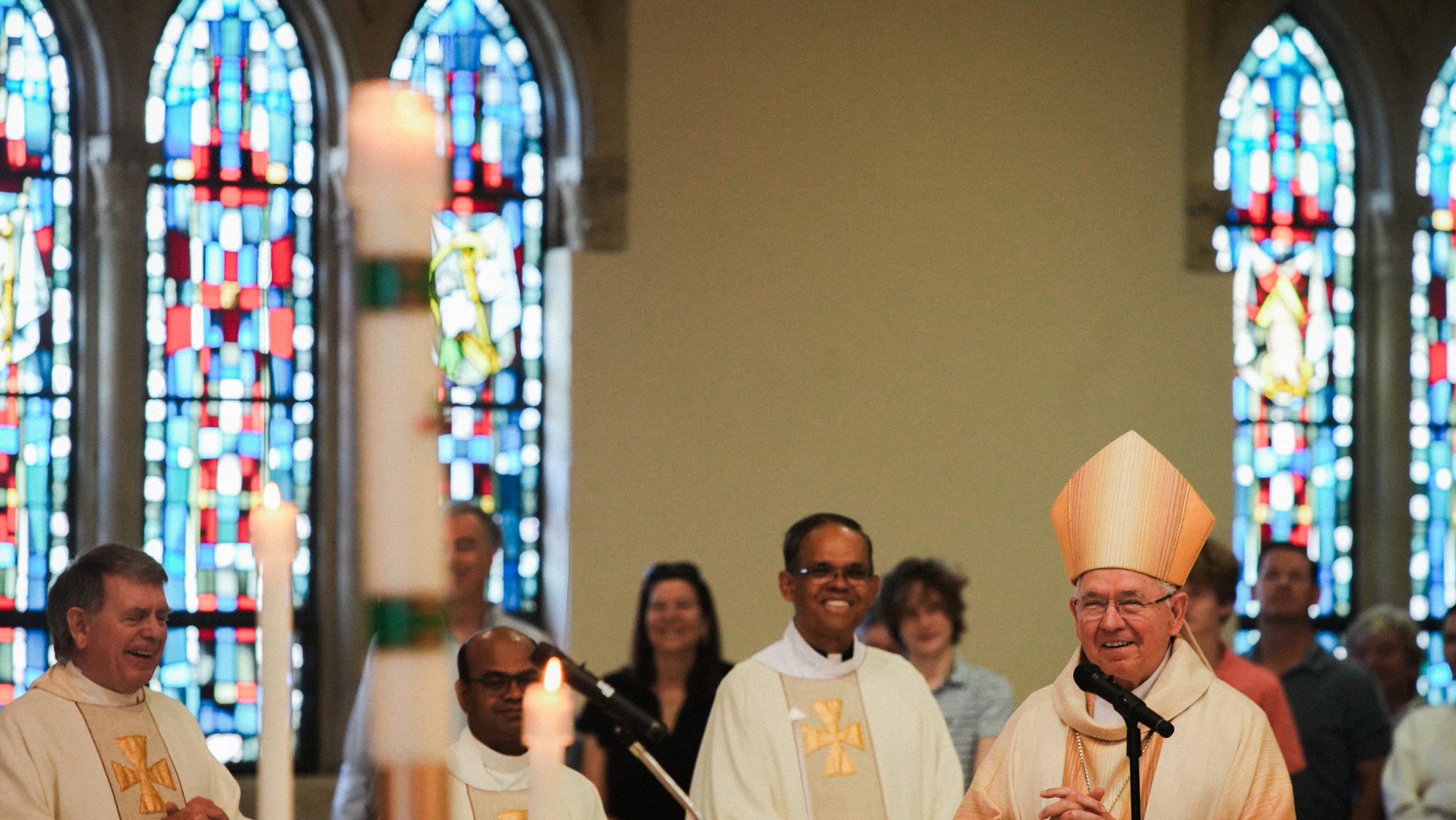 Archbishop José H. Gomez laughs, along with Msgr. Liam Kidney, Father Reegan Jayakuamr Susai Poul, and Father Valerian Menezes, during a Mass to celebrate Corpus Christi Church’s 75th anniversary at Mt. Saint Mary’s University in Brentwood on June 1. (John Geronilla)