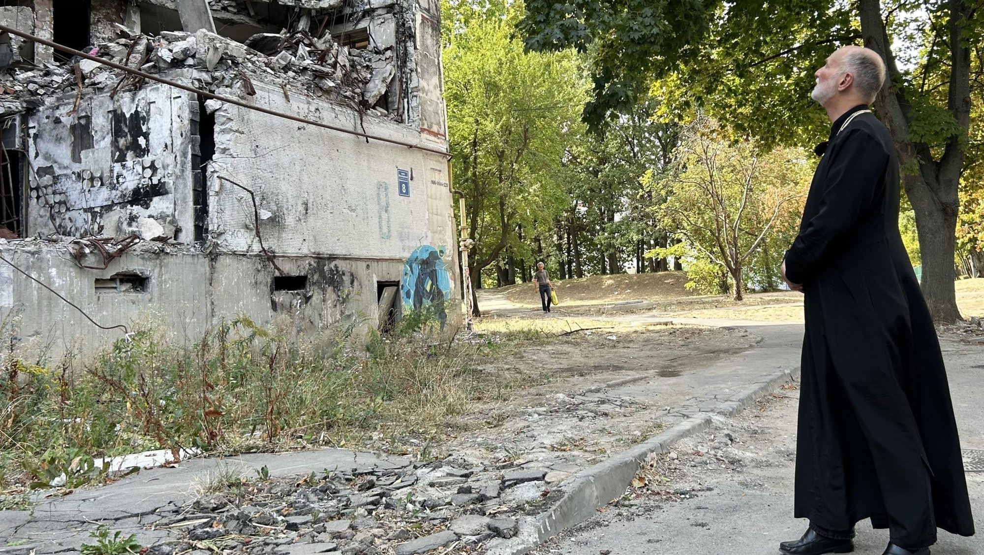 Metropolitan Archbishop A. Gudziak of the Ukrainian Greek Catholic Archeparchy of Philadelphia inspects a residential building Sept. 8, 2024, that was destroyed by Russian glide bombs in Kharkiv, Ukraine, located within 30 miles of the frontline of Russia's 11-year invasion of that nation. (OSV News photo/Gina Christian)
