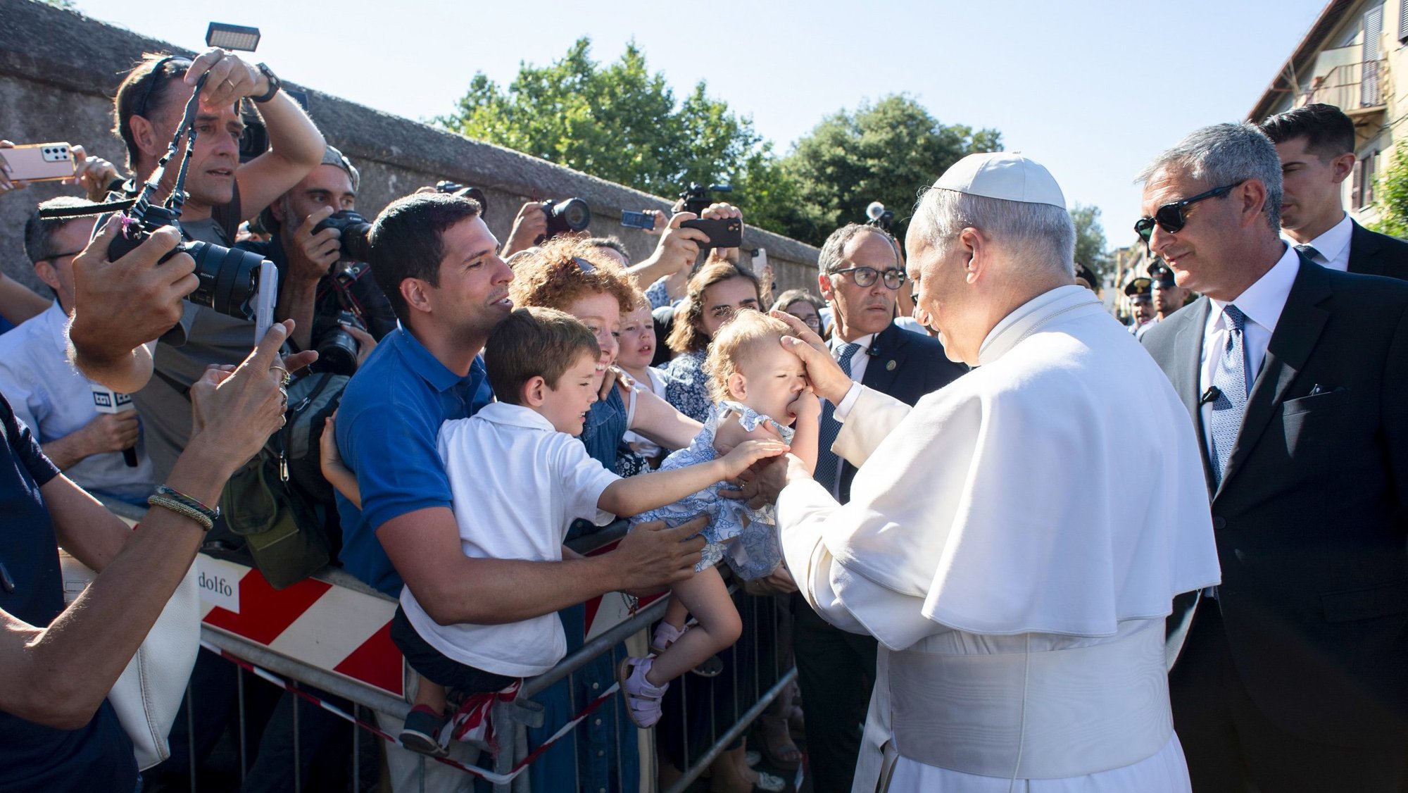 Pope Leo XIV greets children as he arrives in Castel Gandolfo, Italy, July 6, 2025, after reciting the Angelus at the Vatican. The pope will stay in Castel Gandolfo for his customary retreat through July 20. (CNS photo/Vatican Media)