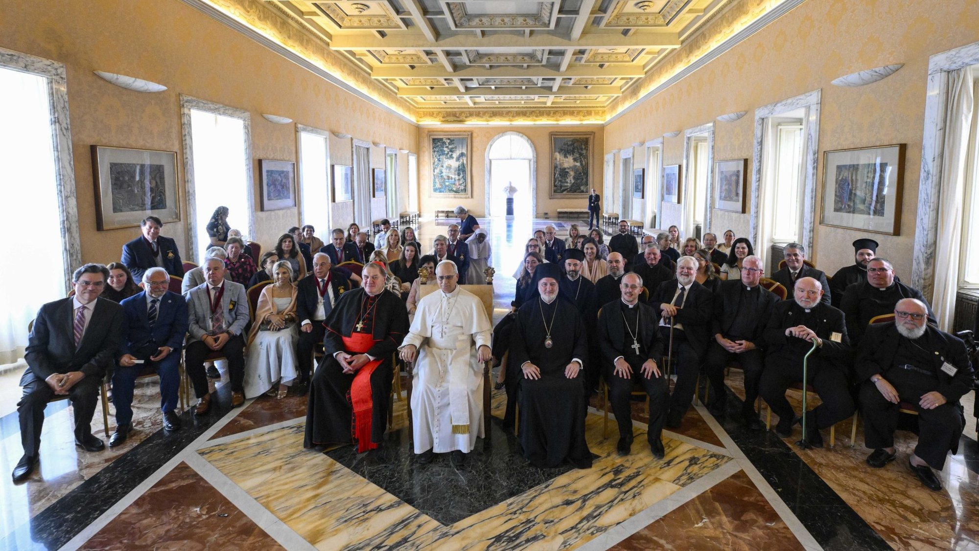 Pope Leo XIV poses for a photo with U.S. visitors at his residence at the papal villa in Castel Gandolfo, Italy, July 17, 2025. The group, led by Cardinal Joseph W. Tobin of Newark, New Jersey, and Greek Orthodox Archbishop Elpidophoros of America, was taking part in an ecumenical pilgrimage to Rome, Istanbul -- formerly known as Constantinople -- and Iznik, Turkey, site of the ancient city of Nicaea. The journey commemorates both the Holy Year dedicated to hope and the 1700th anniversary of the Council of Nicaea. (CNS photo/Vatican Media)