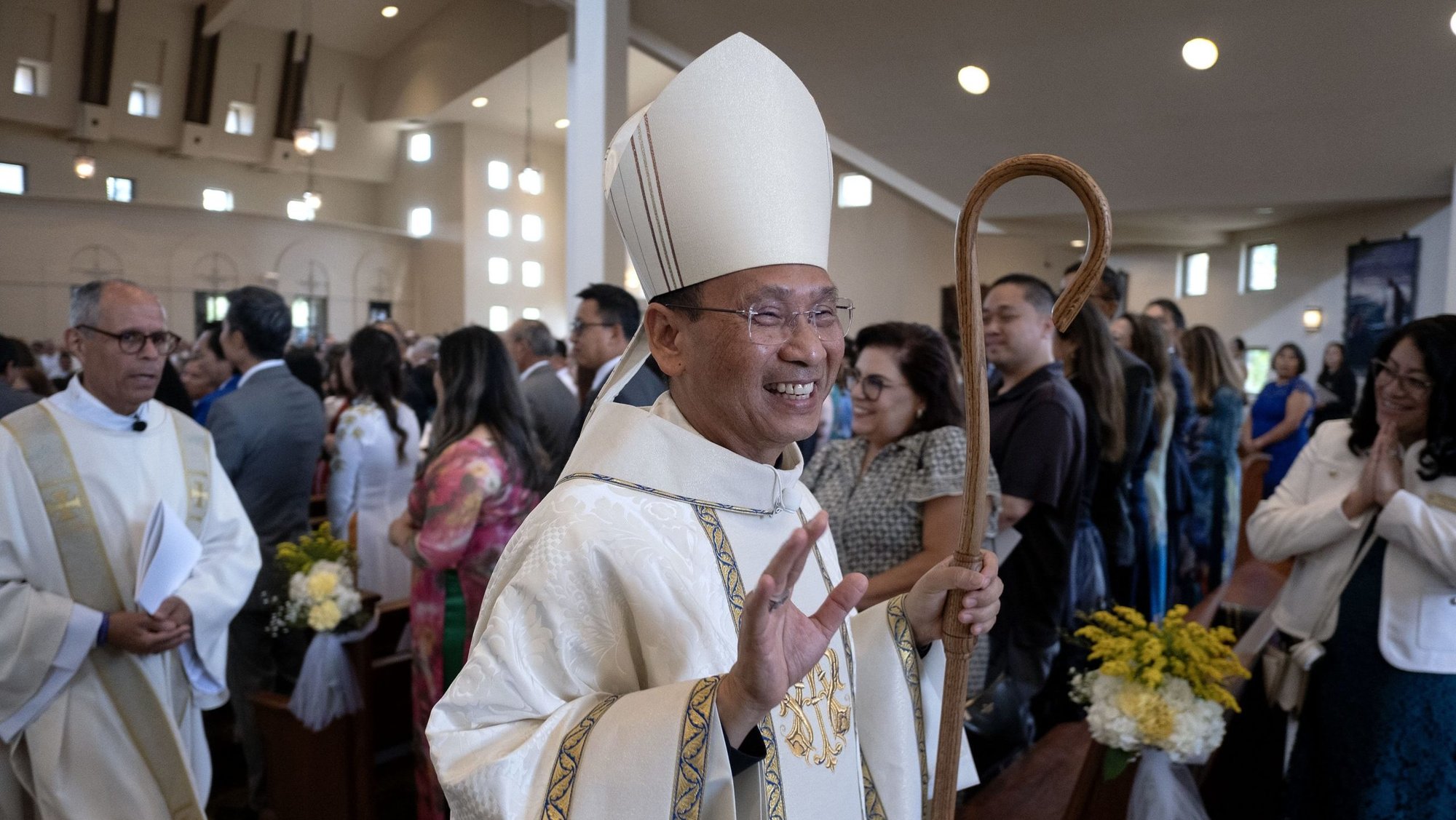 Bishop Michael M. Pham waves as he processes out of St. Therese of Carmel Catholic Church in San Diego, Calif., following his installation as seventh bishop of the Diocese of San Diego July 17, 2025. (OSV News/David Maung, The Southern Cross)