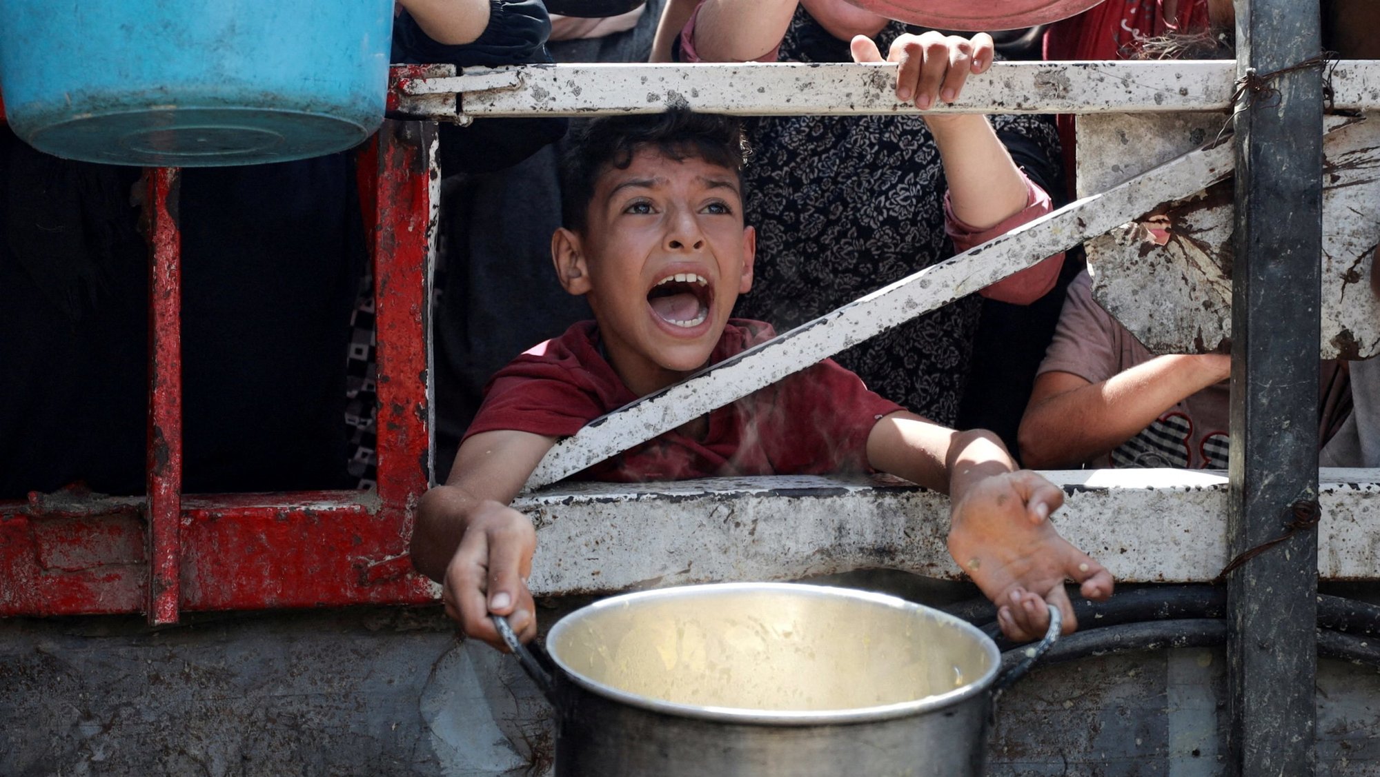 A Palestinian reacts as he waits to receive food from a charity kitchen amid a hunger crisis in the central Gaza Strip July 29, 2025. (OSV News photo/Hatem Khaled, Reuters)