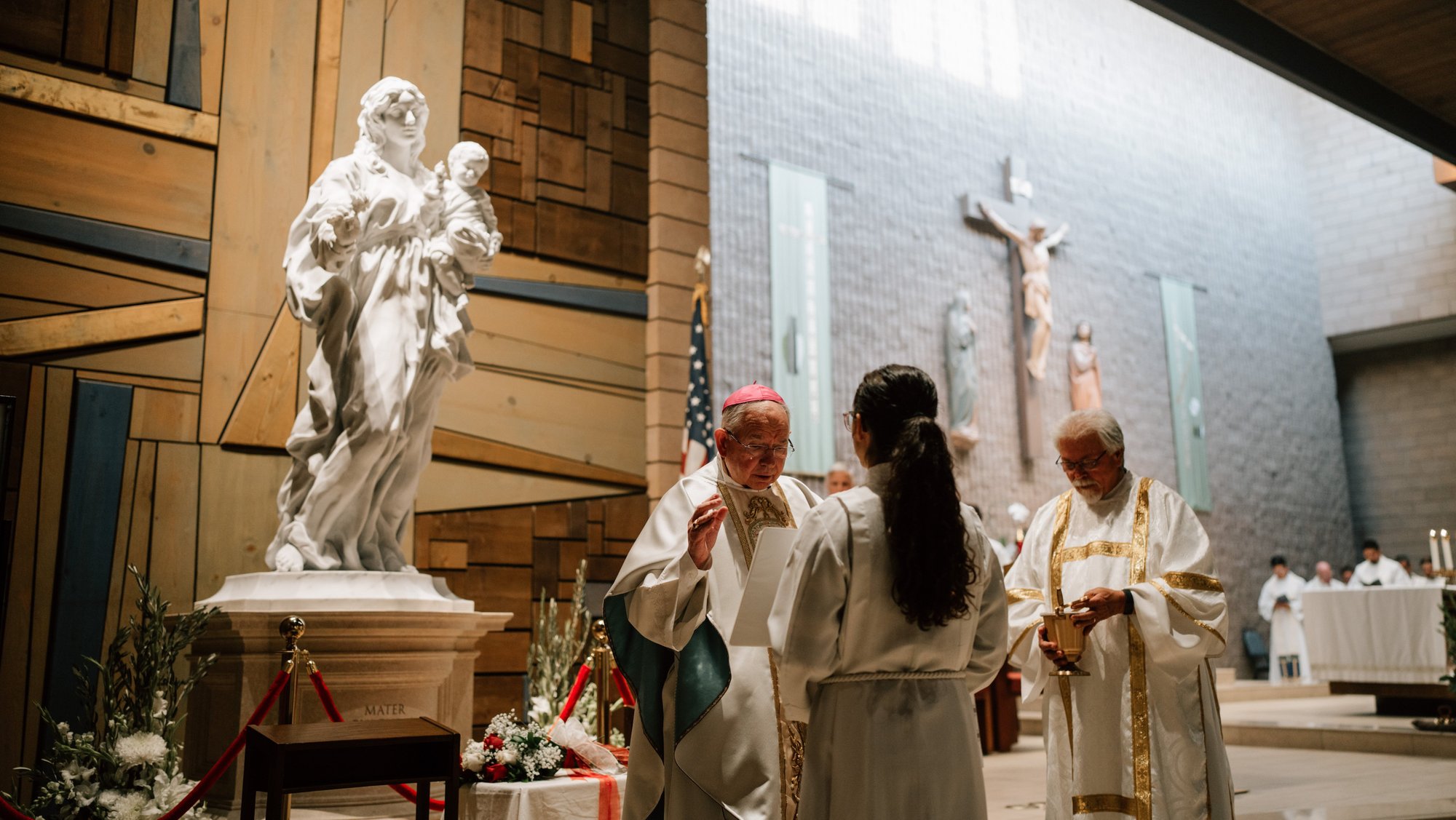 Archbishop José H. Gomez stands in front of the Mary, Mother of Fairest Love statue as he helps consecrate the faithful to the Blessed Mother at St. Louise de Marillac Church in Covina on June 26. (Peter Lobato)