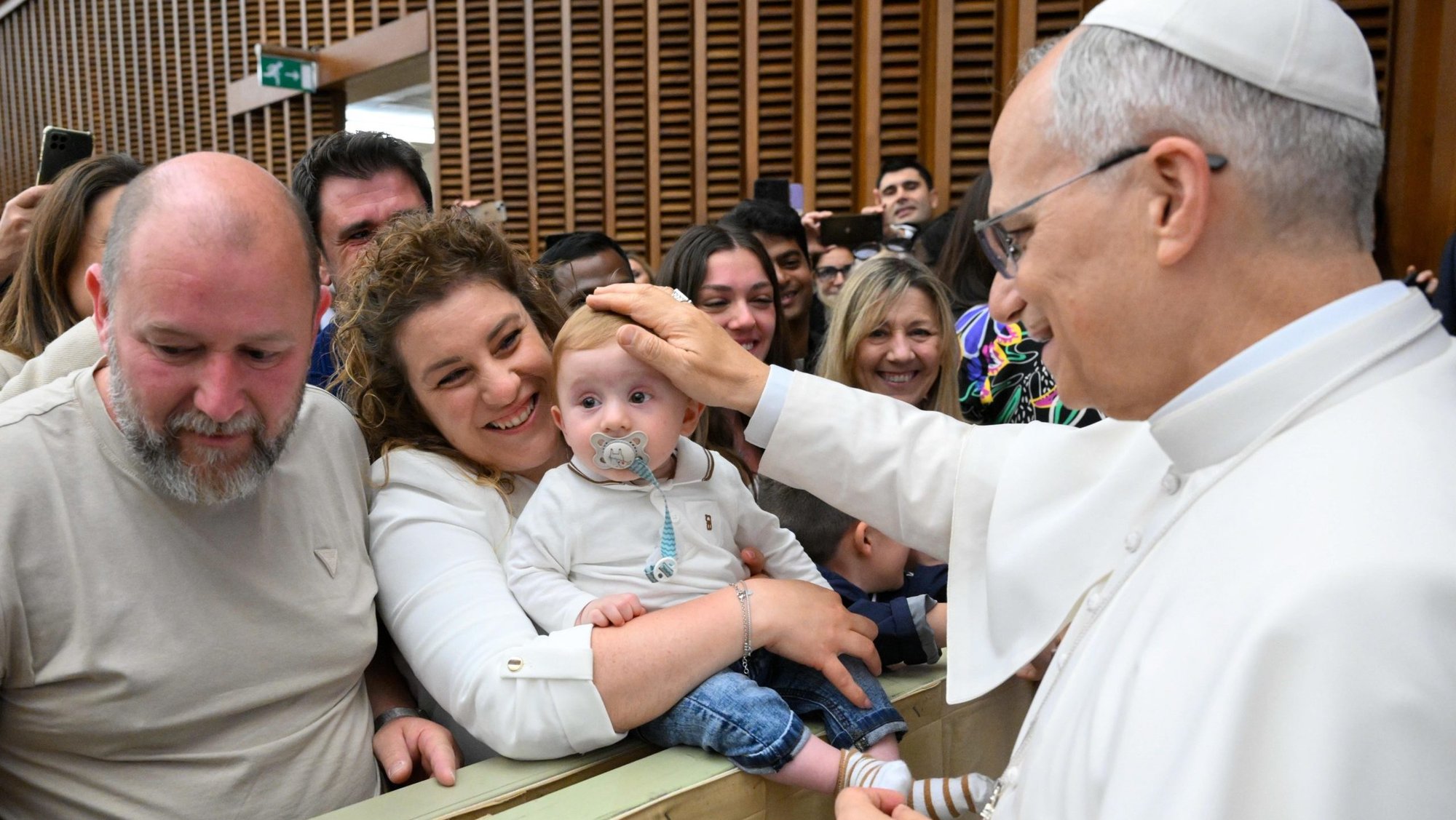 Pope Leo XIV greets a child during a meeting with officials and employees of the Roman Curia, Vatican City State and the Diocese of Rome in the Paul VI Audience Hall at the Vatican May 24, 2025. (CNS photo/Vatican Media)