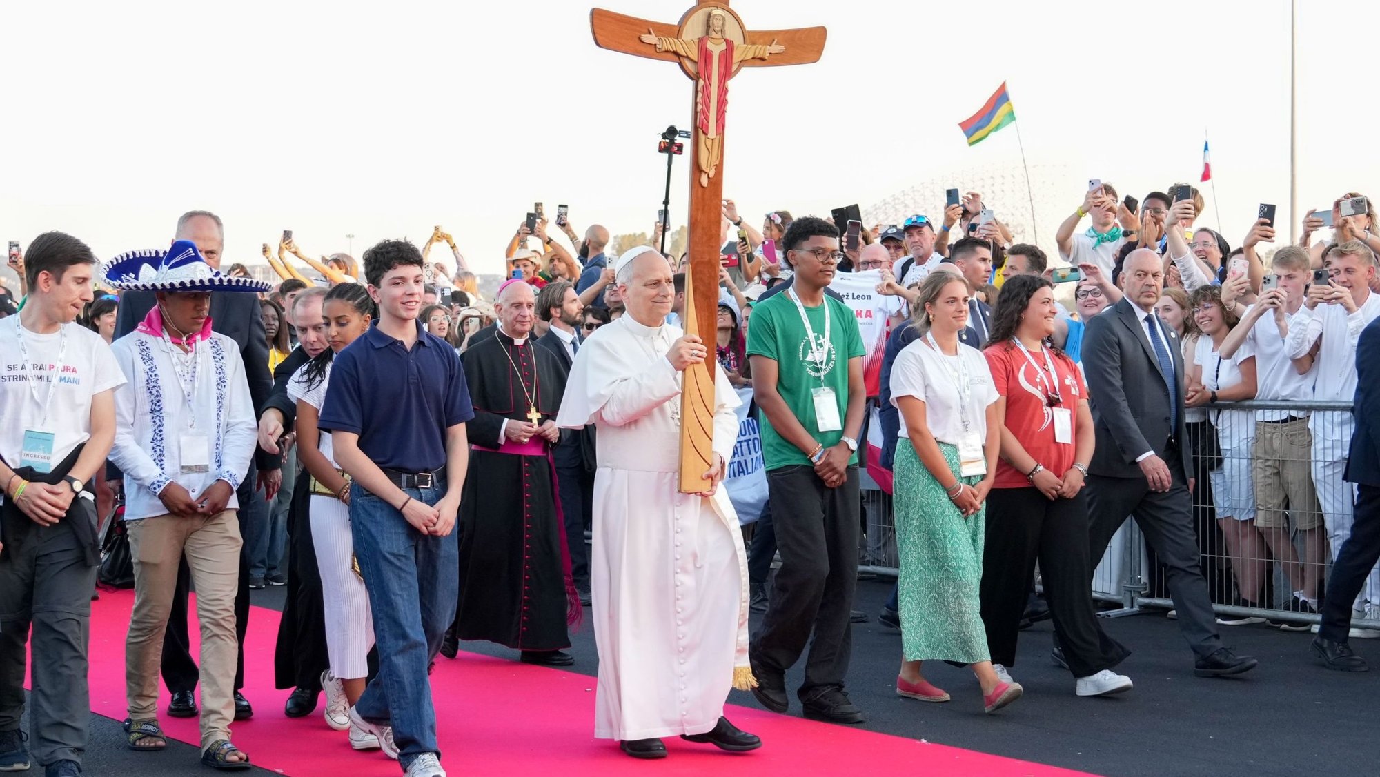 Pope Leo XIV carries the Jubilee Cross as he walks to the altar before the start of a prayer vigil with young people gathered in Tor Vergata in Rome Aug. 2, 2025, during the Jubilee of Youth. (CNS photo/Lola Gomez)