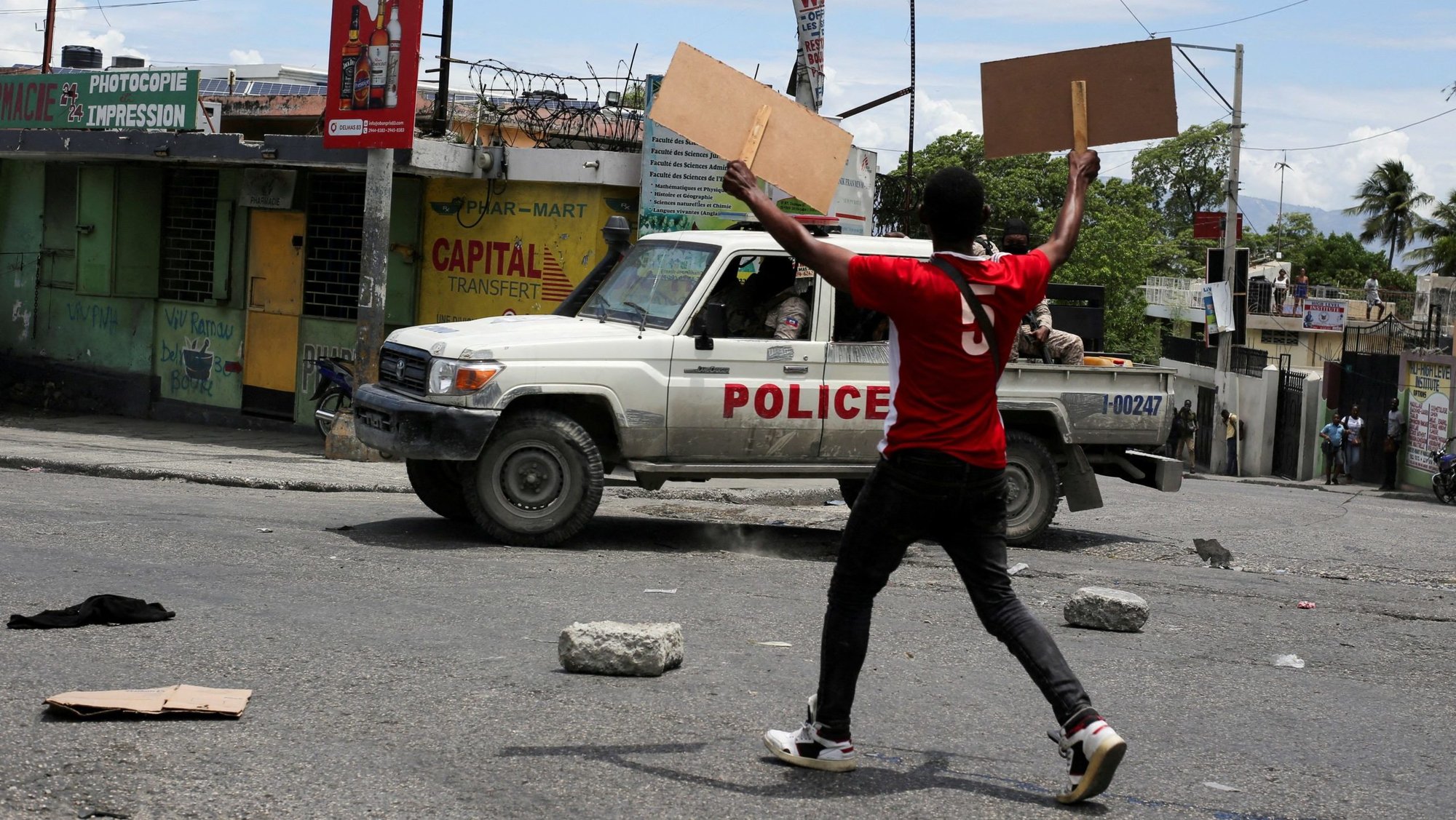A man holds up placards as he yells toward a patrol car during a protest against gang-related violence in Port-au-Prince, Haiti, May 15, 2025, in this file photo. (OSV News photo/Jean Feguens Regala, Reuters)