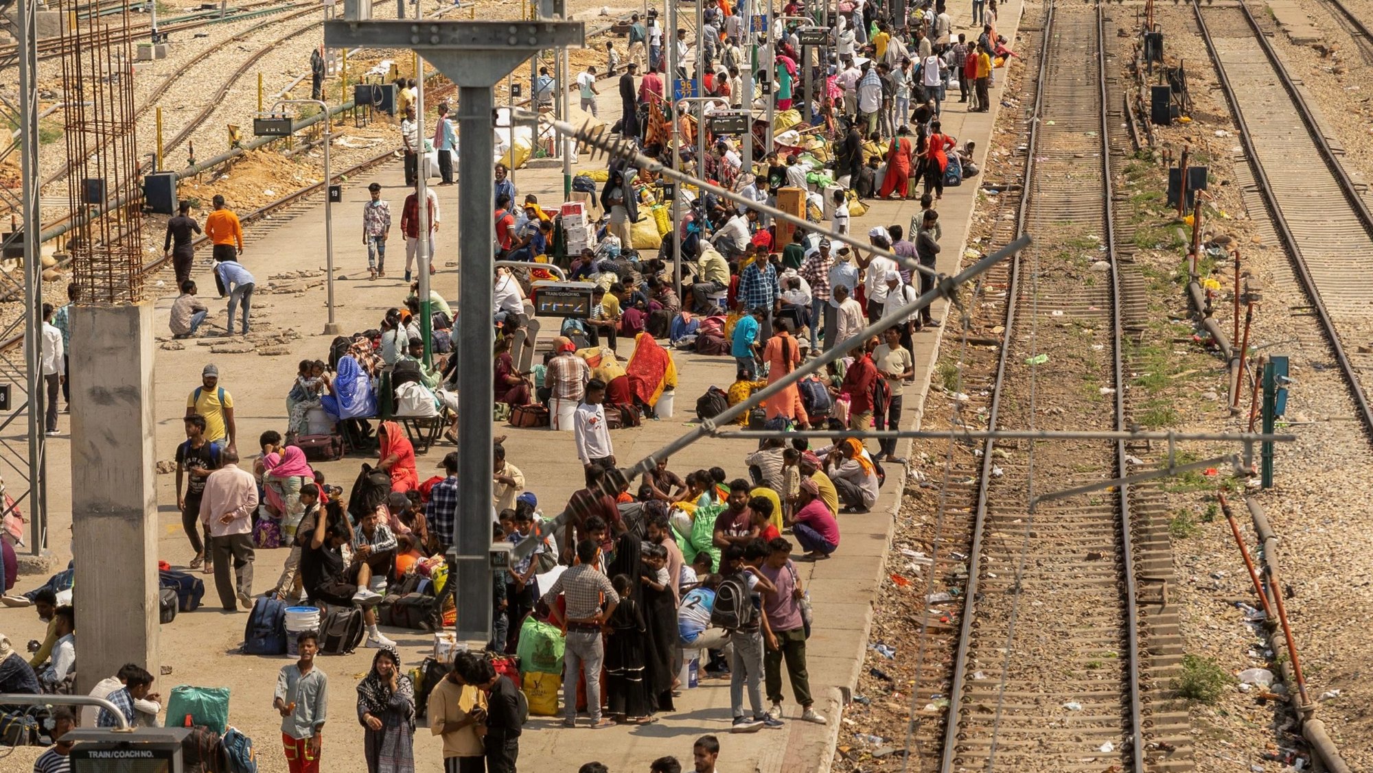 People sit on a platform as they wait to board a train at a railway station in Jammu, India, May 10, 2025. Two Catholic nuns and an Indigenous youth who were arrested on July 25 at Durg railway station in Chhattisgarh state were granted bail and released Aug. 2 under strict conditions. They were arrested for alleged human trafficking and forced conversion in central India. (OSV News photo/Adnan Abidi, Reuters)