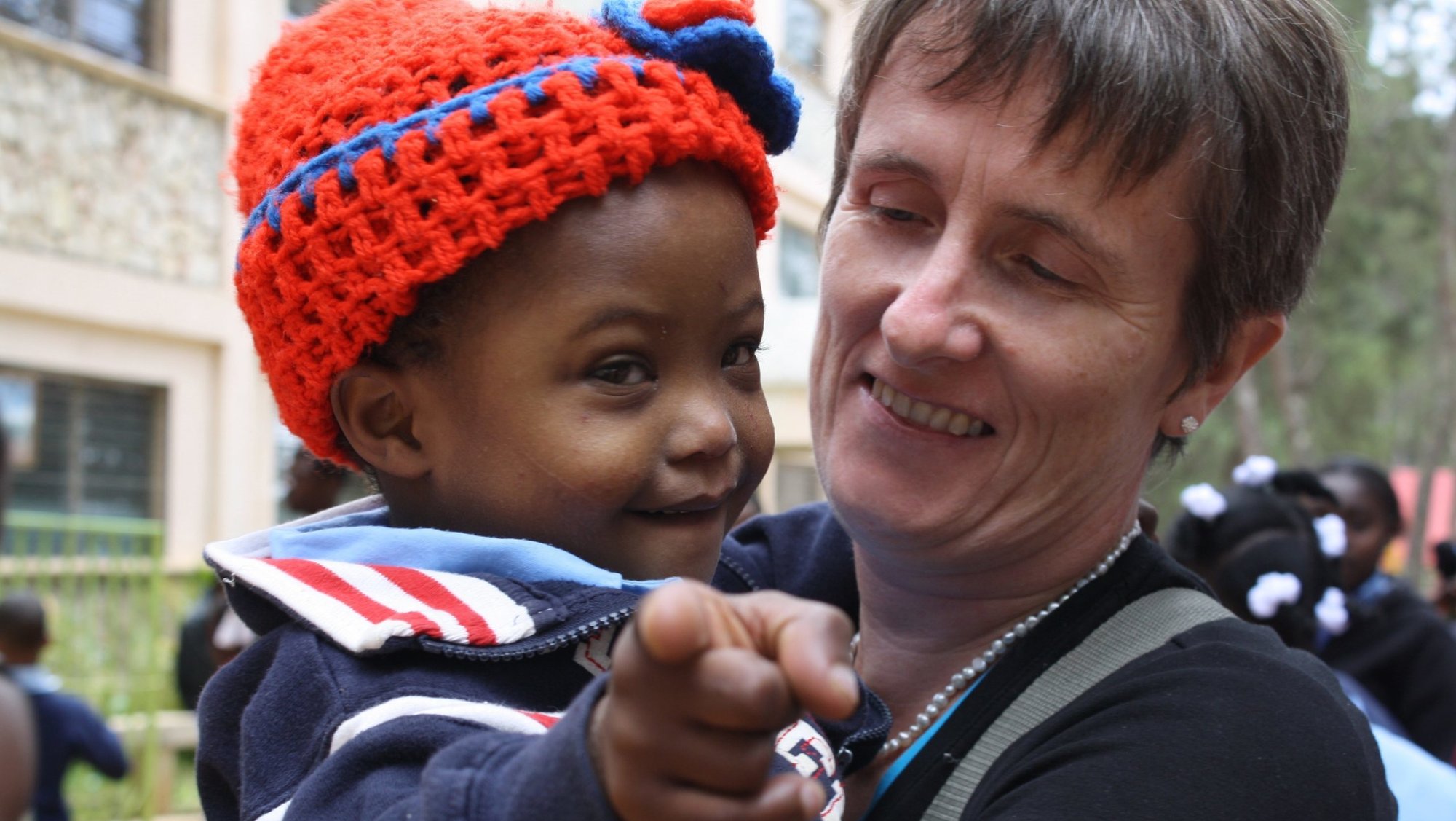Gena Heraty, a longtime Irish missionary in Haiti, is pictured with a child in a 2012 photo. Heraty was among several people -- including a 3-year-old child -- taken in the early hours of Aug. 3, 2025, after gunmen breached the Saint-Hélène orphanage in Kenscoff, near Haiti's capital of Port-au-Prince. (OSV News photo/courtesy NPH International)