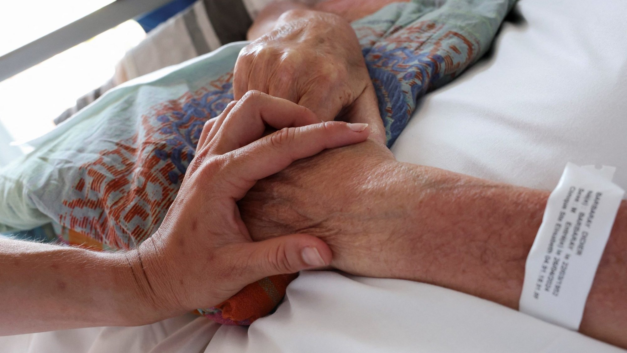 A nurse touches the hand of a patient in the palliative care unit of the Clinic Saint-Elisabeth in Marseille, France, May 31, 2024. In an Aug. 13, 2025, statement The Uruguay bishops' conference expressed sadness after the country's lower house of Congress approved a bill decriminalizing euthanasia. (OSV News photo/Manon Cruz, Reuters)