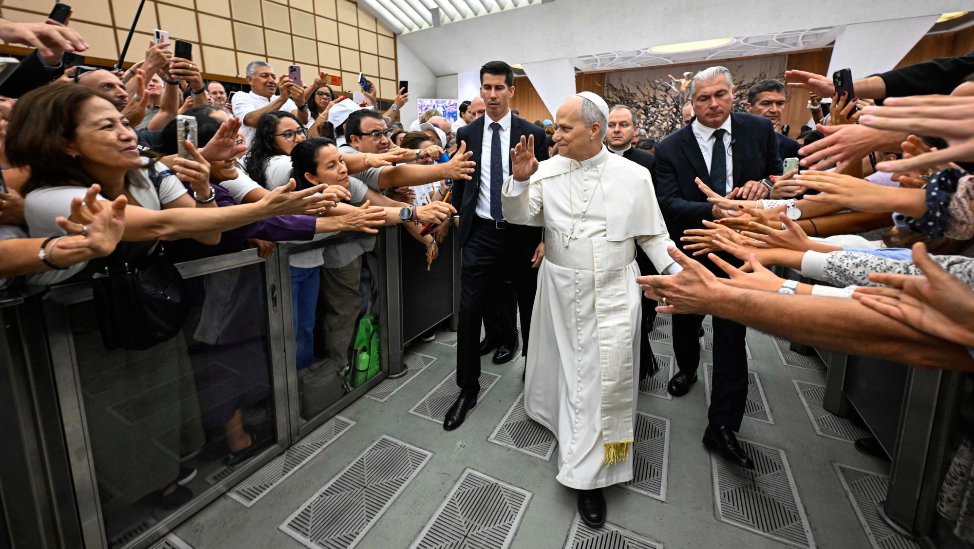 Pope Leo XIV greets people as he leaves the Paul VI Audience Hall at the Vatican after his weekly general audience Aug. 27, 2025. (CNS photo/Vatican Media)
