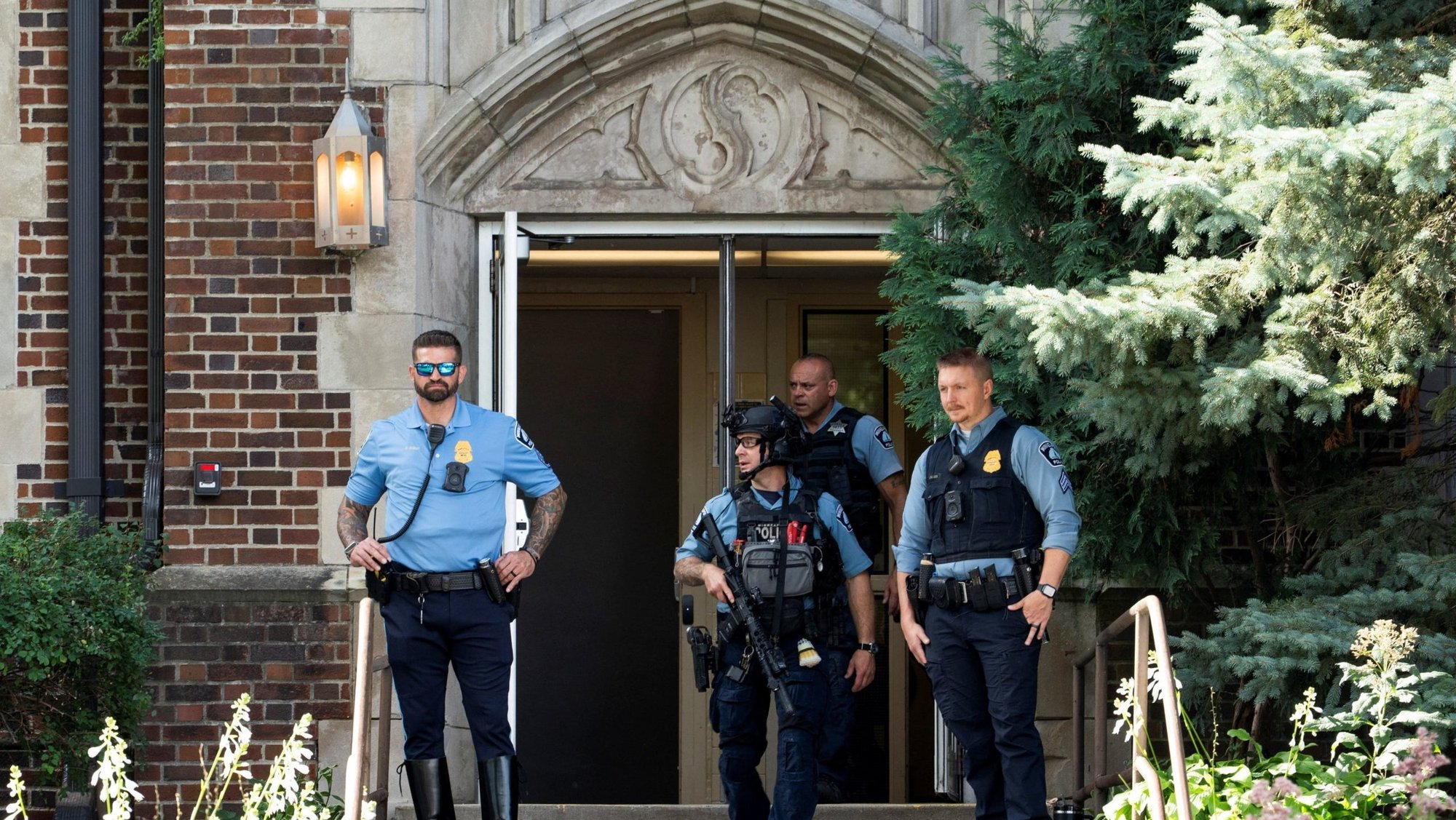 Following a shooting at Annunciation Church, first responders stand at the entrance to nearby Annunciation Catholic School in Minneapolis Aug. 27, 2025. A shooter opened fire with a rifle through the windows of the church and struck children attending Mass during the first week of school, killing two and wounding 21 people in an act of violence the police chief called "absolutely incomprehensible." (OSV News photo/Tim Evans, Reuters)