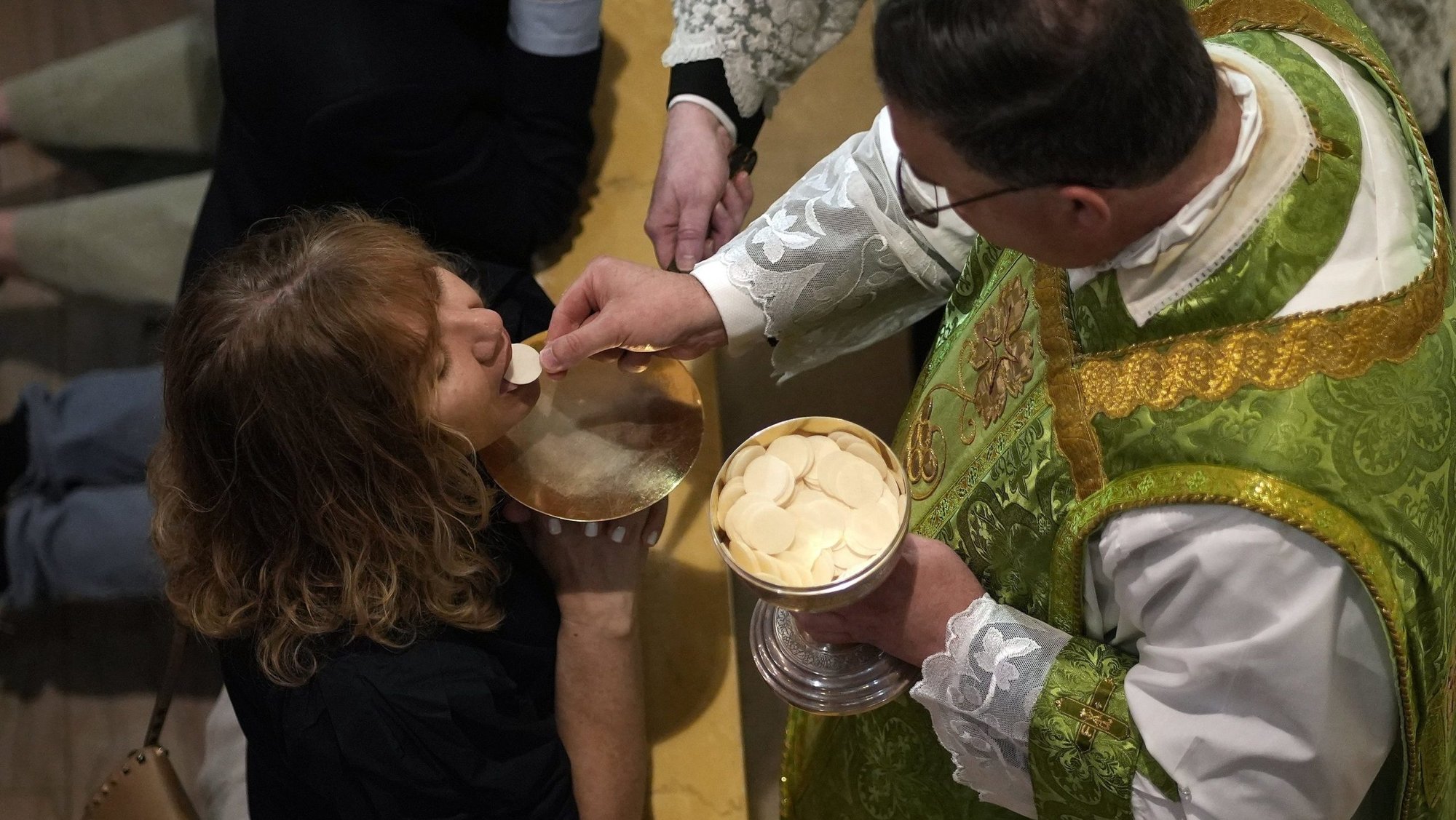 A worshipper receives Communion from Father James Miara, pastor of Holy Innocents Church in New York City, during a traditional Latin Mass at Holy Innocents July 13, 2025. (OSV News photo/Gregory A. Shemitz)