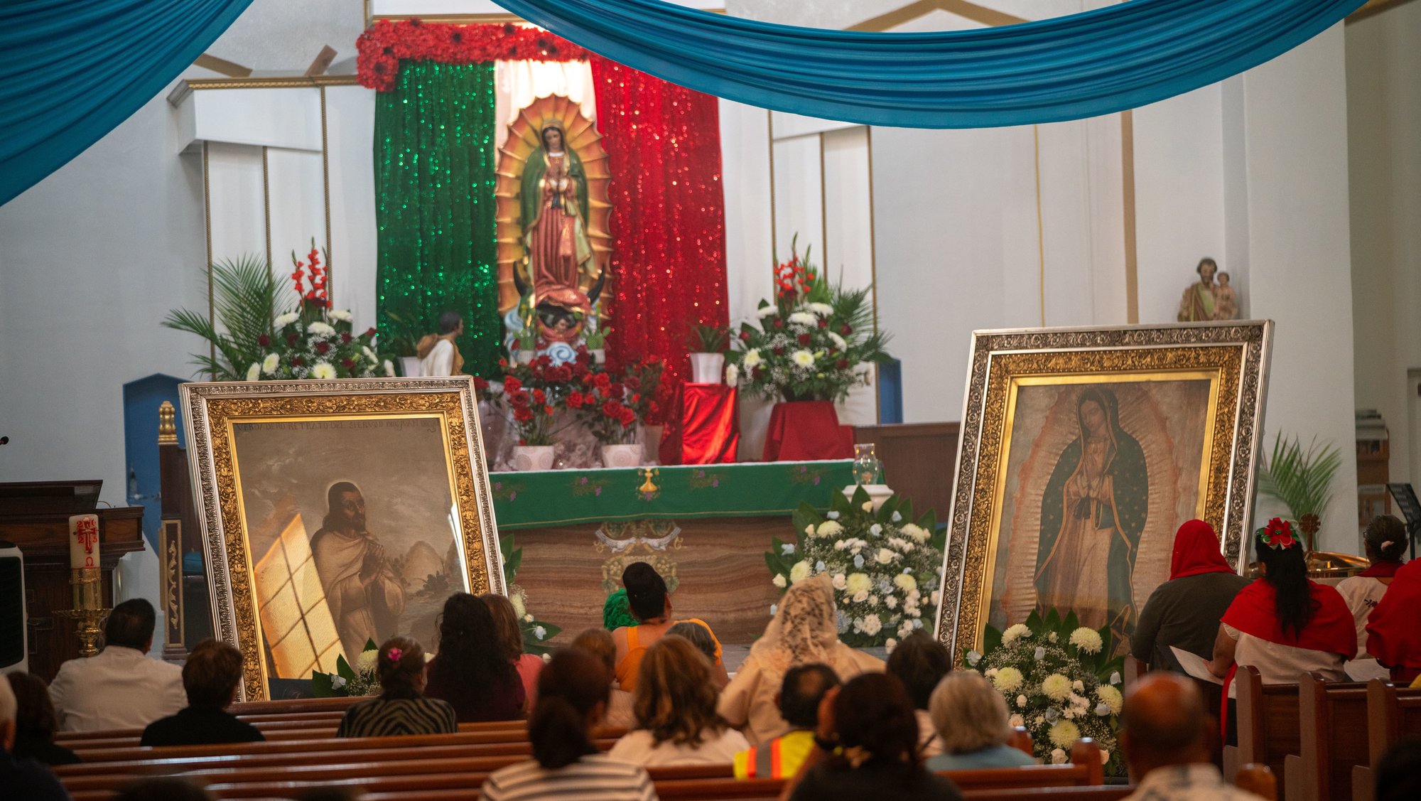 Parishioners at Our Lady of Lourdes Church in East LA pray in front of the pilgrim images of Our Lady of Guadalupe and St. Juan Diego. (John Rueda)