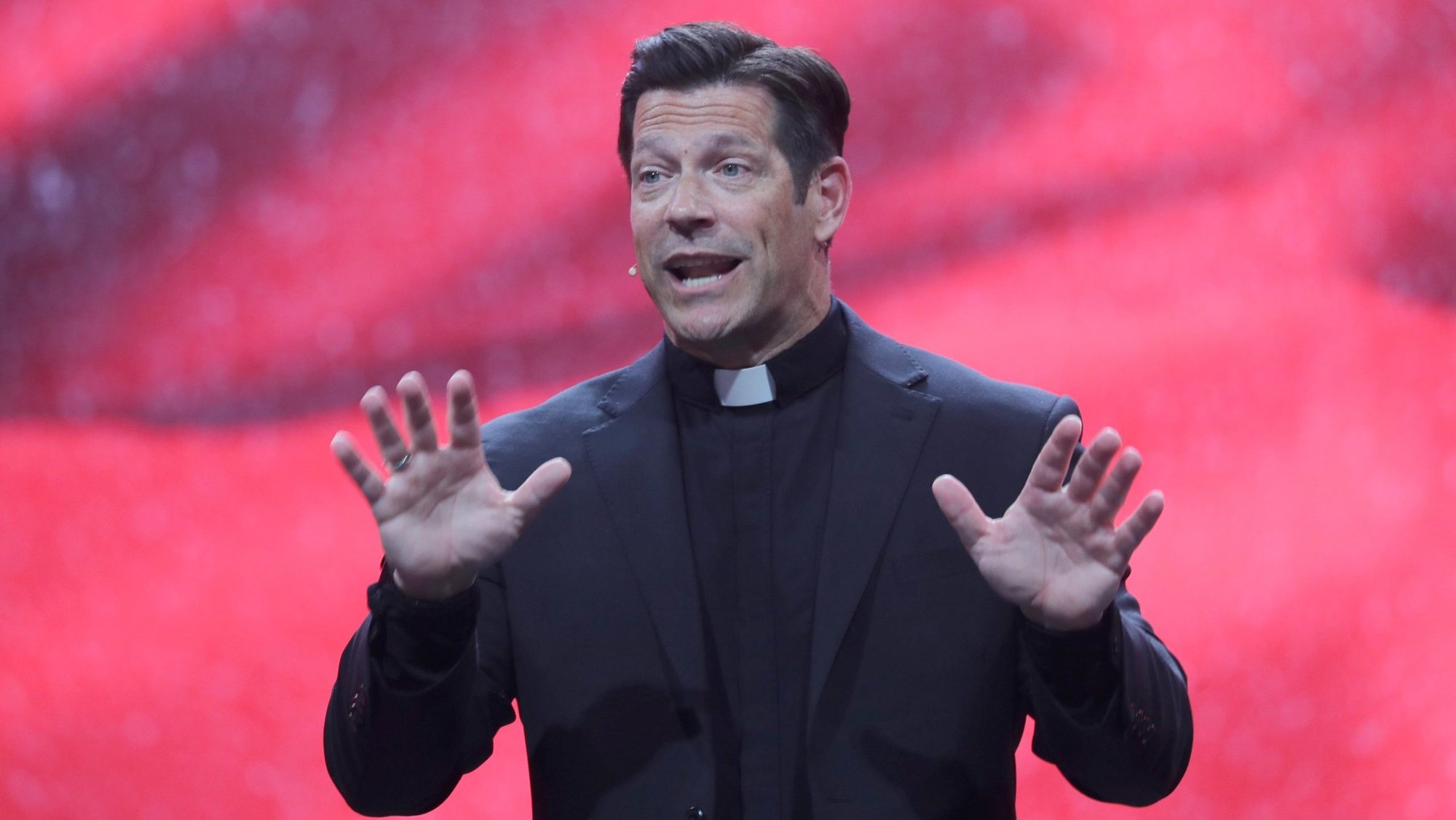Father Mike Schmitz, popular podcaster and director of youth and young adult ministry for the Diocese of Duluth, Minn., speaks July 18, 2024, during the National Eucharistic Congress at Lucas Oil Stadium in Indianapolis. Father Schmitz, of "The Bible in a Year" fame, will be hosting the fourth season of Ascension's "Catholic Classics" podcast focusing on the 15th-century spiritual classic "The Imitation of Christ." (OSV News photo/Bob Roller)