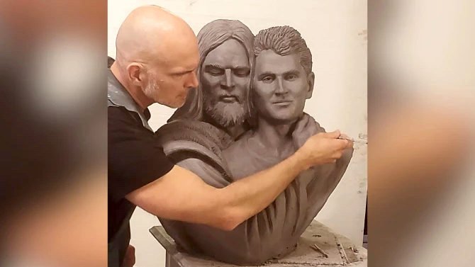 Timothy Schmalz works on the sculpture of Jesus embracing and wrapping his own wounded hand around Charlie Kirk. (Courtesy of Ave Maria University via CNA)