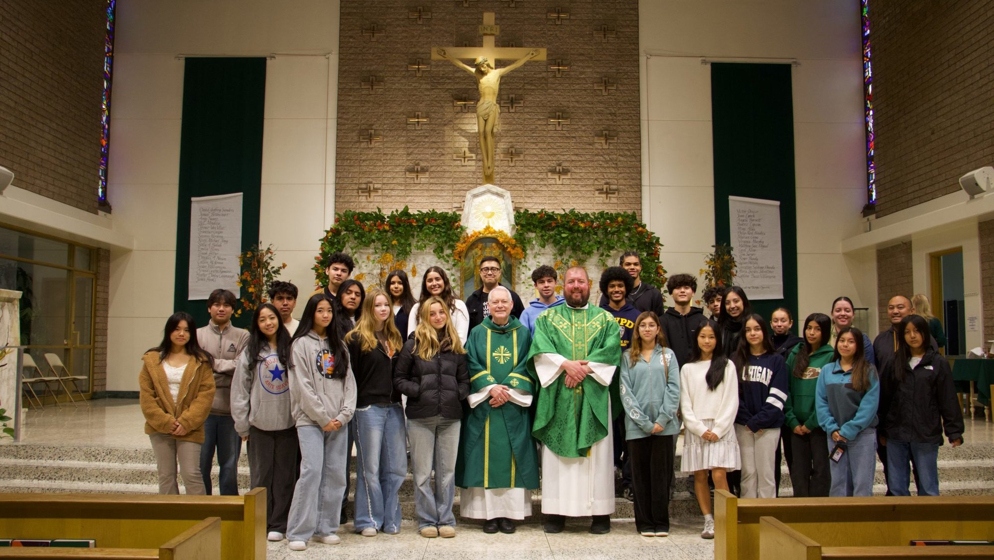 Bishop Matthew Elshoff, center, and Father Max Villeneuve, OSA, pastor at Our Mother of Good Counsel Church in Los Feliz, pose with confirmation students following the “Stand Up Sunday” Mass at the parish on Nov. 16. (Kimmy Chacón)
