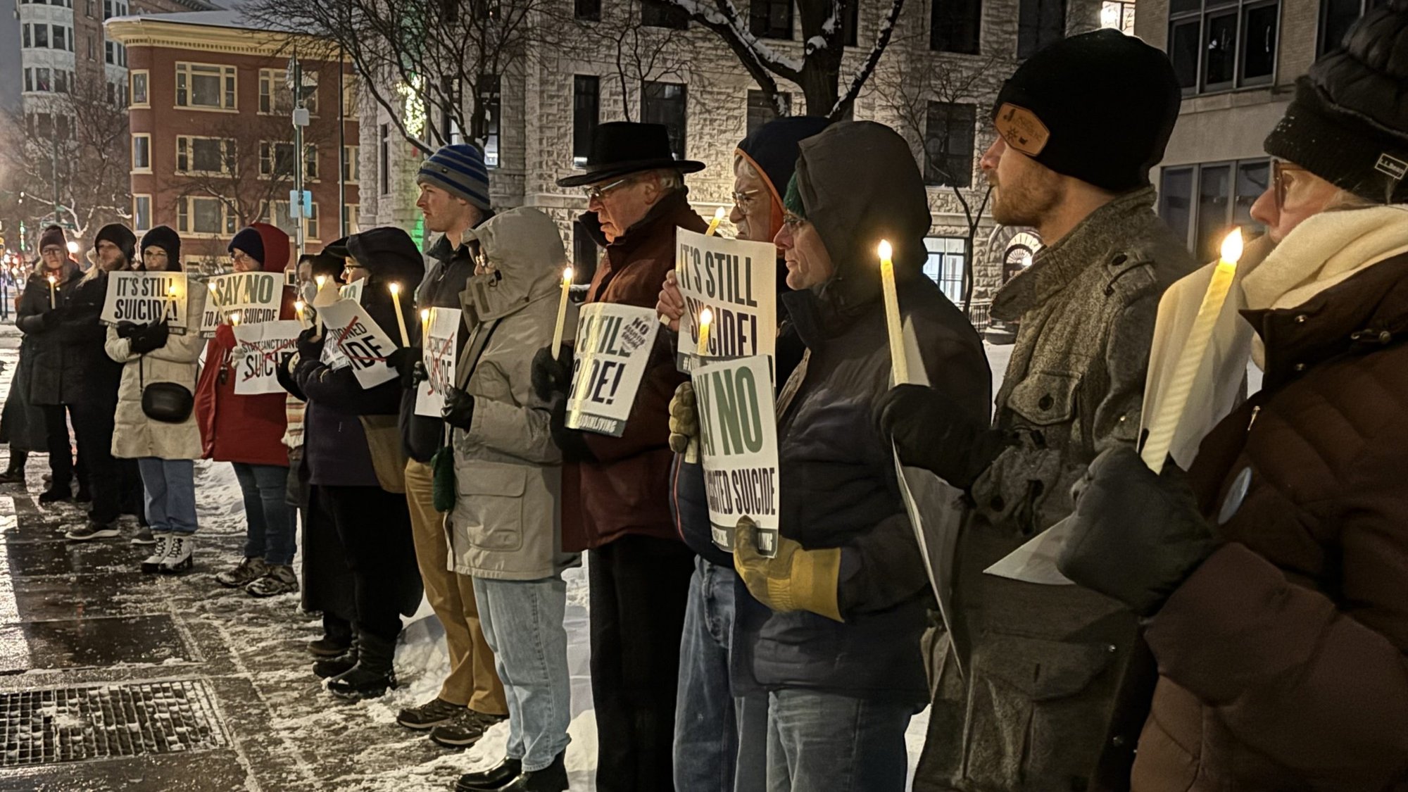 People attend a candlelight vigil outside the Sen. John H. Hughes Office Building in downtown Syracuse, N.Y., Dec. 4, 2025, to speak out against a controversial bill that, should it become law, would allow physicians to assist terminally ill adults as young as age 18 to die by suicide. (OSV News/Tami S. Scott, The Catholic Sun)
