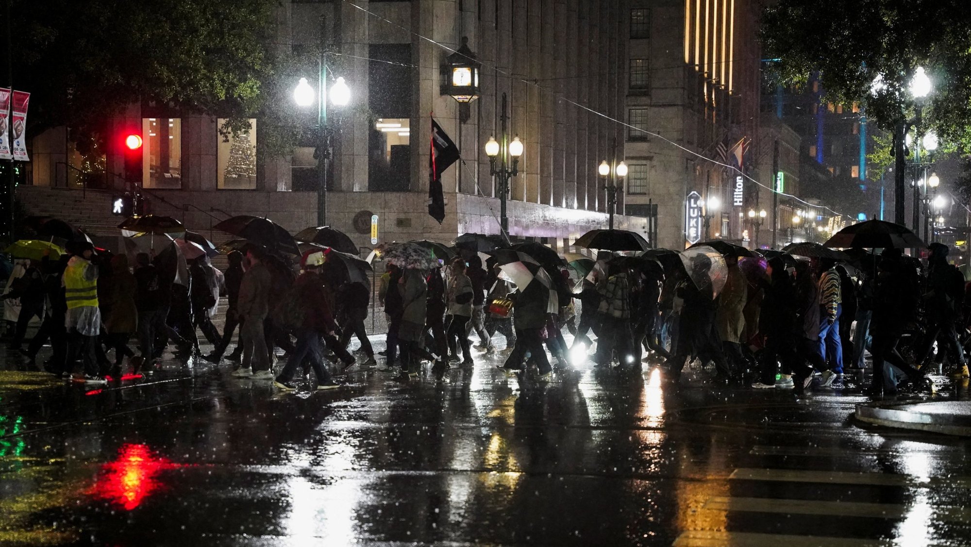 People holding umbrellas in the rain attend a protest against U.S. Immigration and Customs Enforcement (ICE) and U.S. Customs and Border Protection (CBP), amid reports that the U.S. Department of Homeland Security is planning to deploy federal border agents to southeast Louisiana, at Lafayette Square, in New Orleans, La., Dec. 1, 2025. Bishop Michael G. Duca of Baton Rouge issued a dispensation Dec. 4 from the obligation to attend Mass for those Catholics who are "rightfully afraid to participate in Mass because of their fear" of immigration enforcement actions. (OSV News photo/Seth Herald, Reuters)