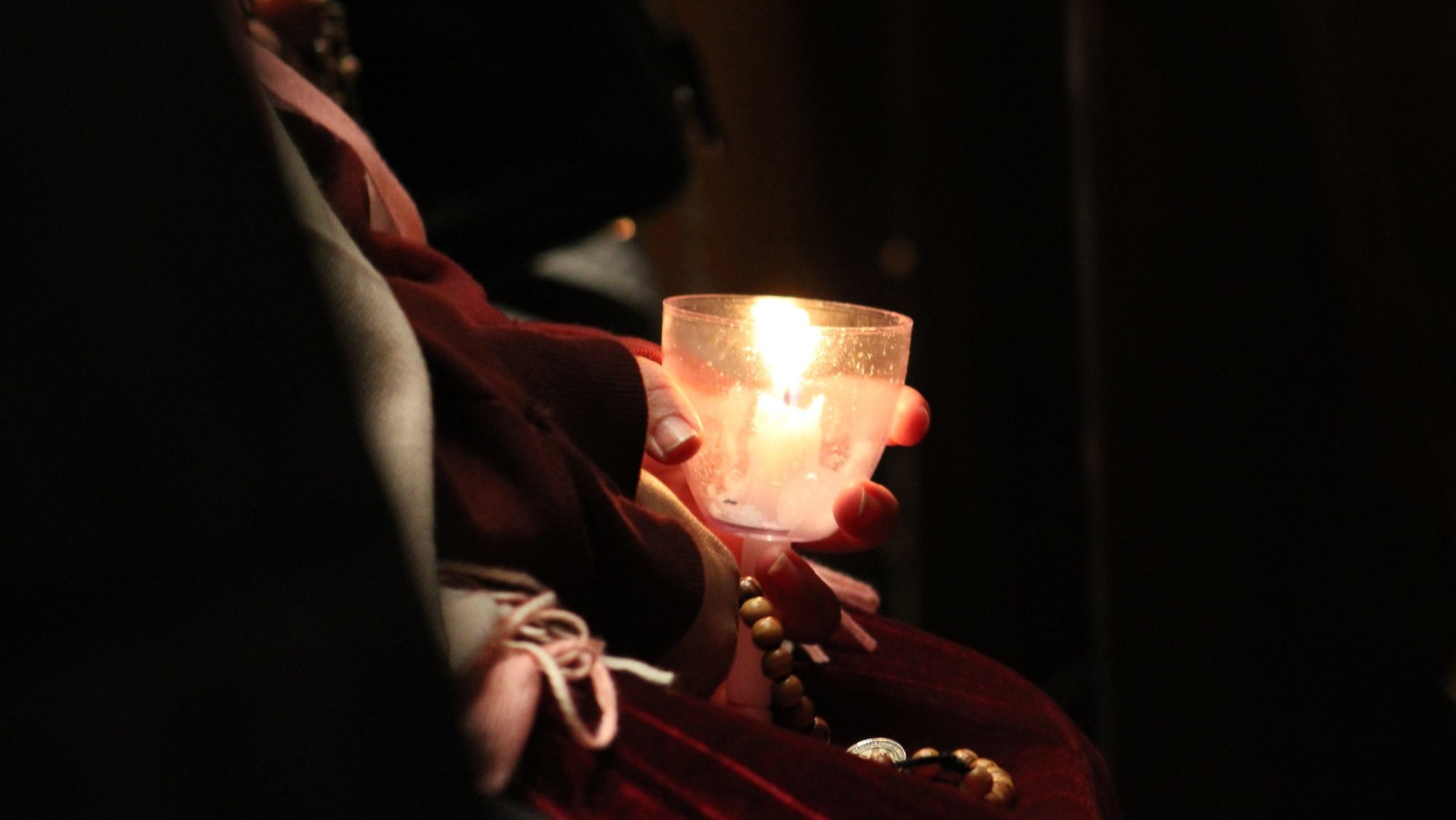 A woman holds a candle during a candlelight rosary for immigrants ahead of a vigil Mass for the feast of Our Lady of Guadalupe celebrated Dec. 11, 2025, at the Cathedral Basilica of Sts. Peter and Paul in Philadelphia. (OSV News photo/Gina Christian)