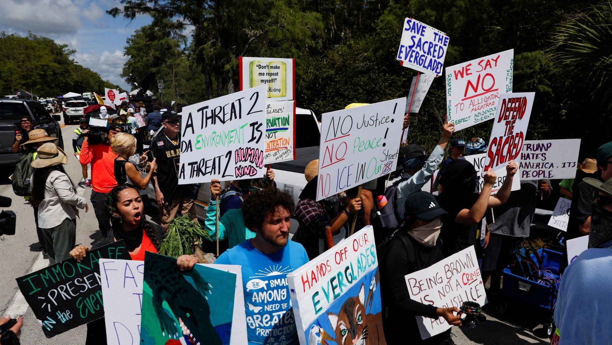 Protesters flank an entrance road at a temporary migrant detention center nicknamed "Alligator Alcatraz" in Ochopee, Fla., July 1, 2025. (OSV News/Octavio Jones, Reuters)