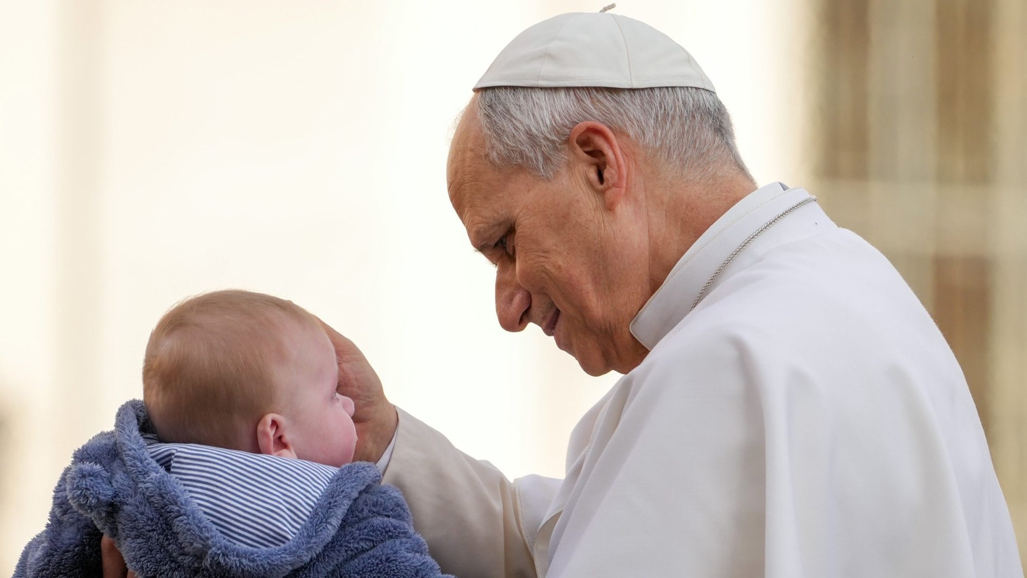 Pope Leo XIV greets a child from the popemobile as he rides around St. Peter's Square at the Vatican before his weekly general audience Dec. 17, 2025. (CNS photo/Lola Gomez)
