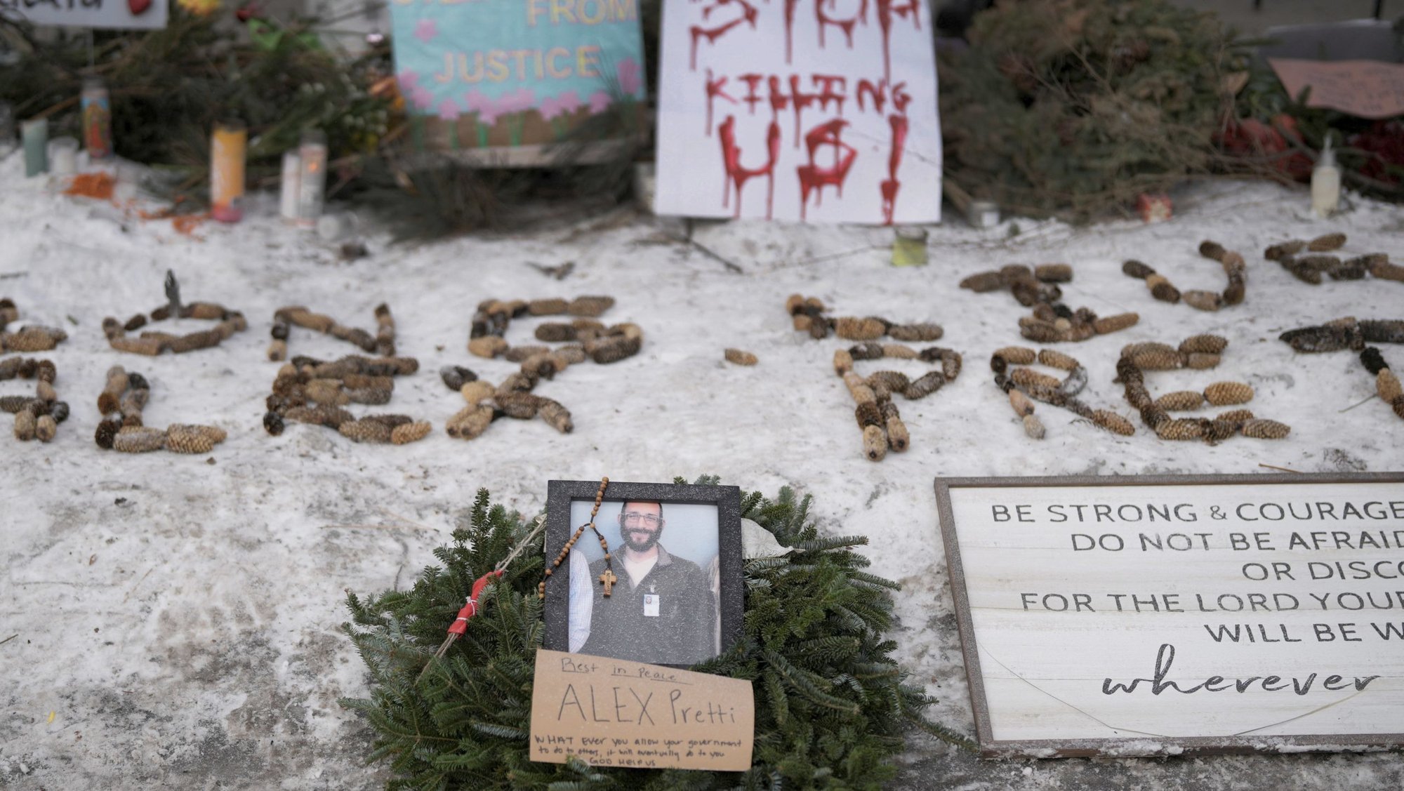 A rosary hangs from a portrait of Alex Pretti, a 37-year-old intensive care unit nurse, at a makeshift memorial in Minneapolis Jan. 25, 2026, at the site where Pretti was fatally shot by federal agents trying to detain him Jan. 24. Archbishop Bernard A. Hebda of St. Paul and Minneapolis, along with other Church leaders, have called for peace amid growing tensions. (OSV News photo/Tim Evans, Reuters)