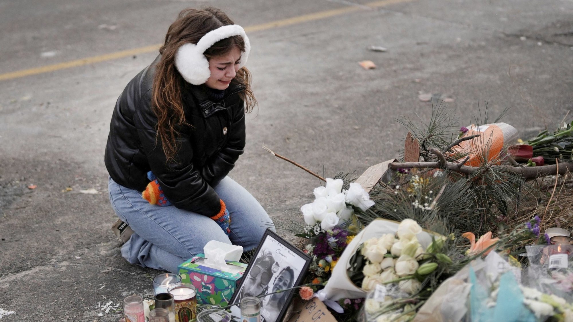 A young woman visits a makeshift memorial in Minneapolis Jan. 25, at the site where a man was fatally shot by federal agents trying to detain him Jan. 24. Archbishop Bernard A. Hebda of St. Paul and Minneapolis, along with other Church leaders, has called for peace amid growing tensions. (OSV News/Tim Evans, Reuters)