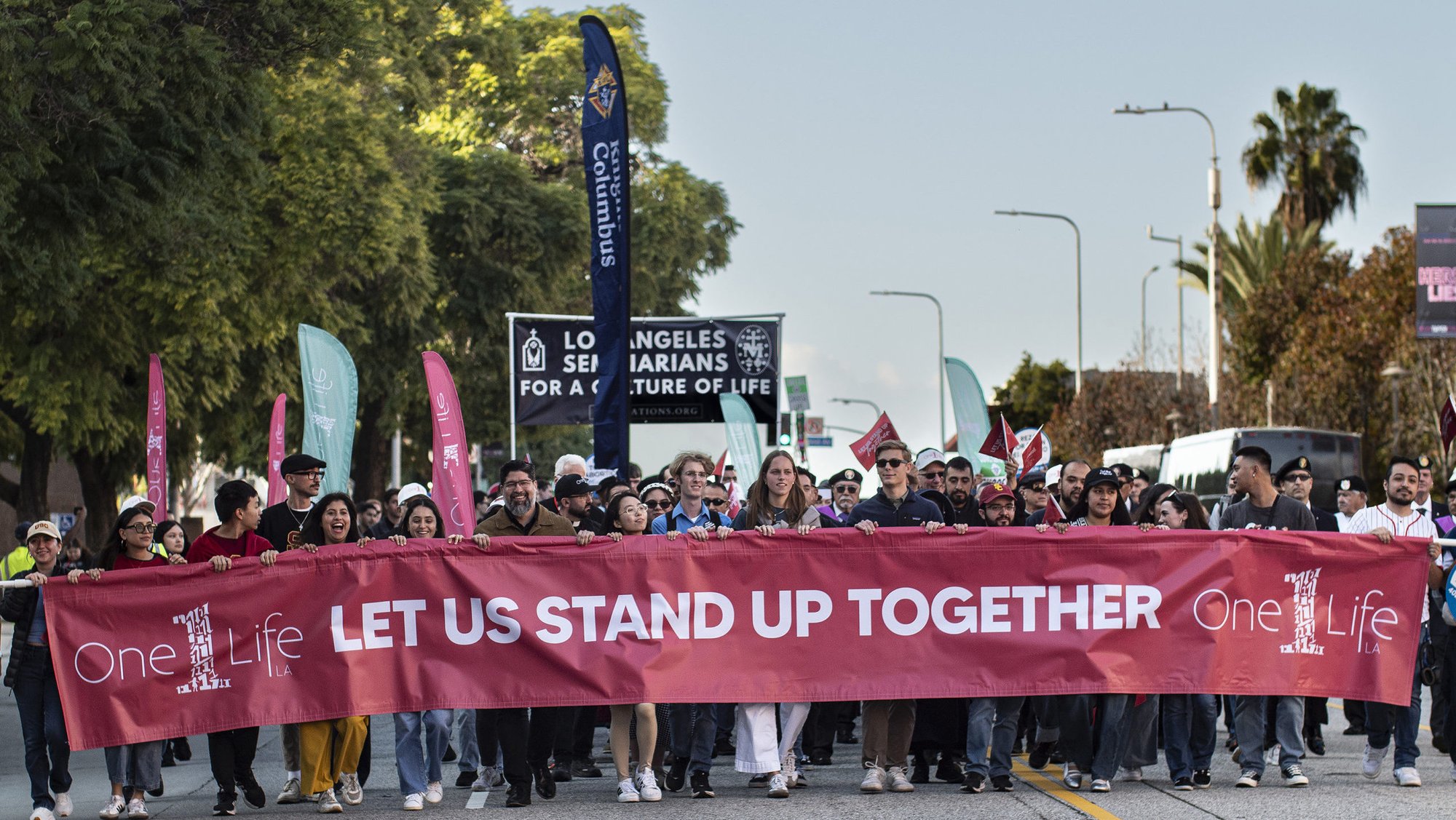 The front of the procession holds a banner during the “Walk for Life” through the streets of downtown Los Angeles as part of the OneLife LA celebration on Jan. 24. (Juanito Holandez Jr.)