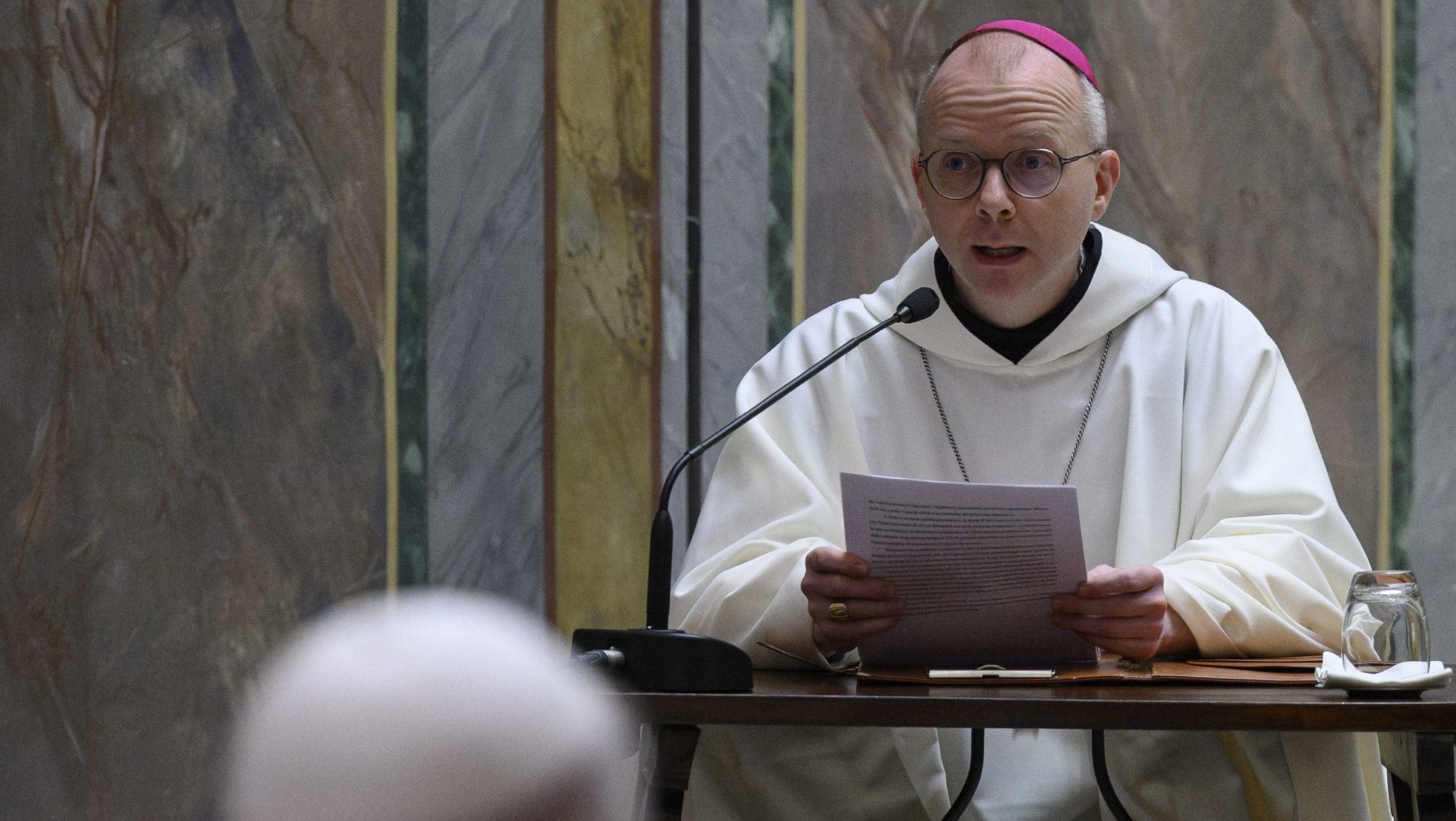 Pope Leo XIV, in foreground, listens as Norwegian Bishop Erik Varden of Trondheim leads the Roman Curia's annual Lenten retreat in the Pauline Chapel at the Vatican Feb. 22, 2026. The Norwegian bishop was chosen by Pope Leo to preach at the Lenten retreat, which runs from Feb. 22 to 27, and will reflect on the theme, "Illuminated by a Hidden Glory." (OSV News photo/Simone Risoluti, Vatican Media)